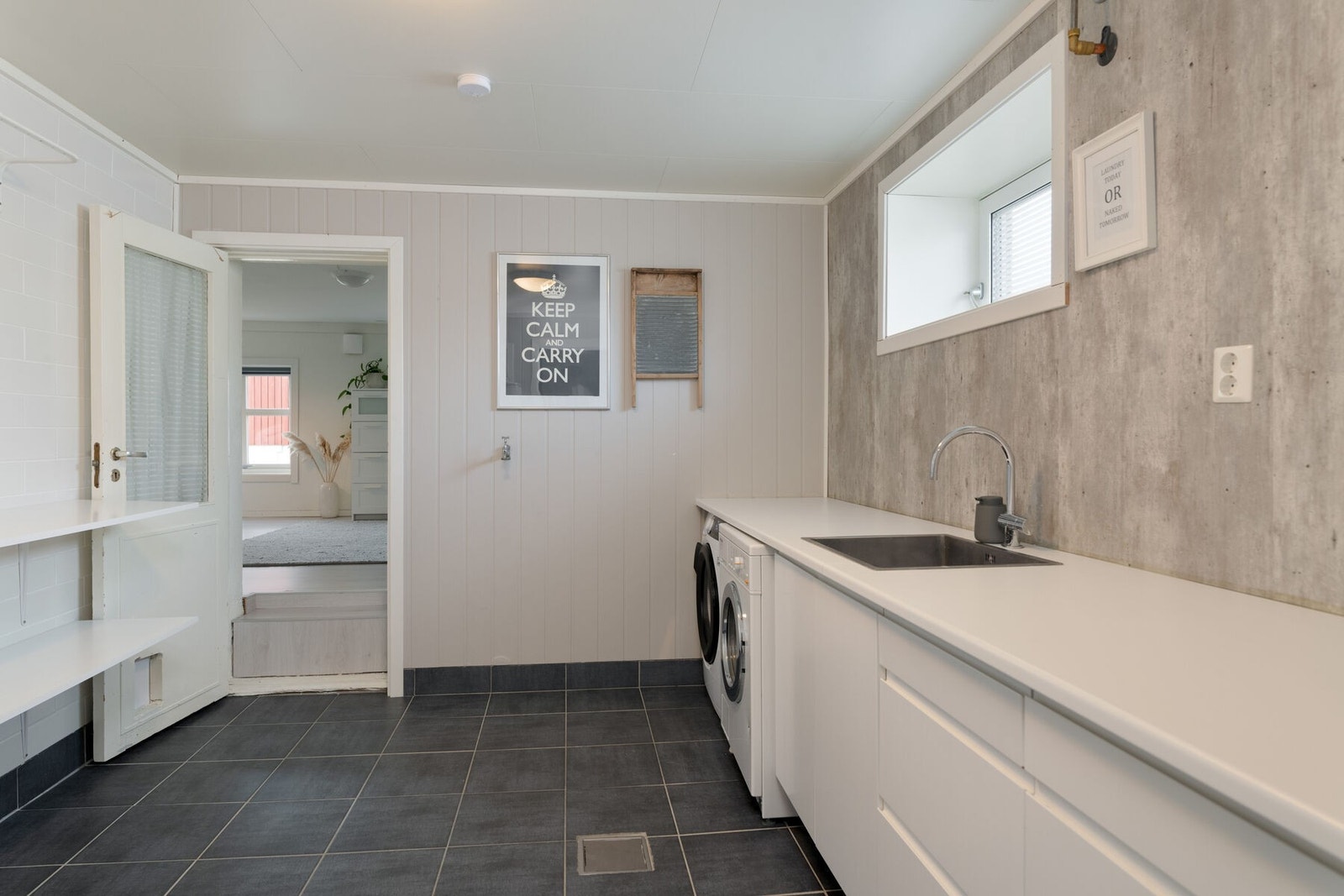 Romslig vaskerom med opplegg for vaskemaskin og innredning med nedfelt vask, og god skapplass. Galleribilde