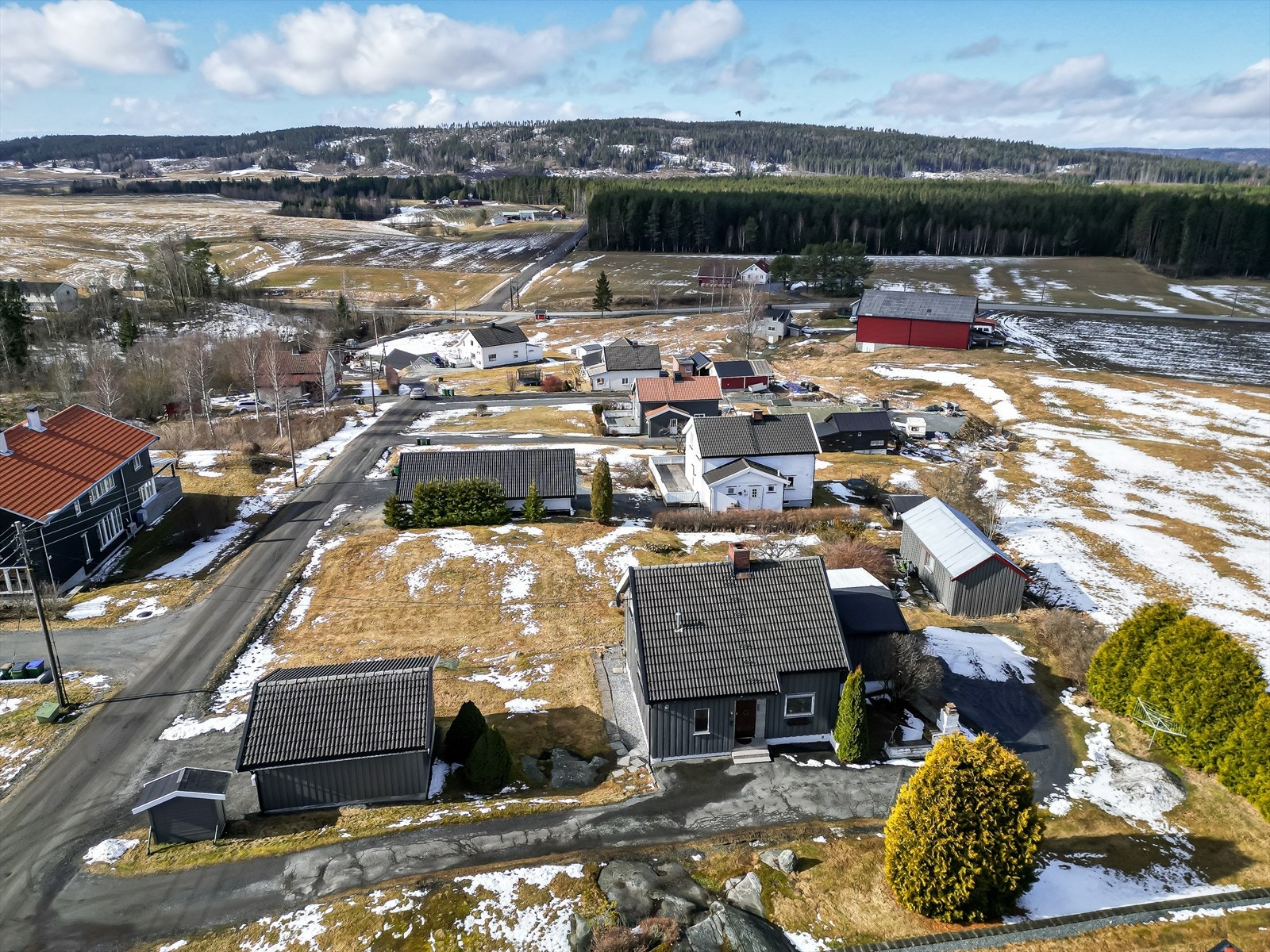 Landlig område med spredt bebyggelse, åpent og fritt, med nydelig utsikt utover bølgende åkerlapper og grønnkledd skog. Galleribilde