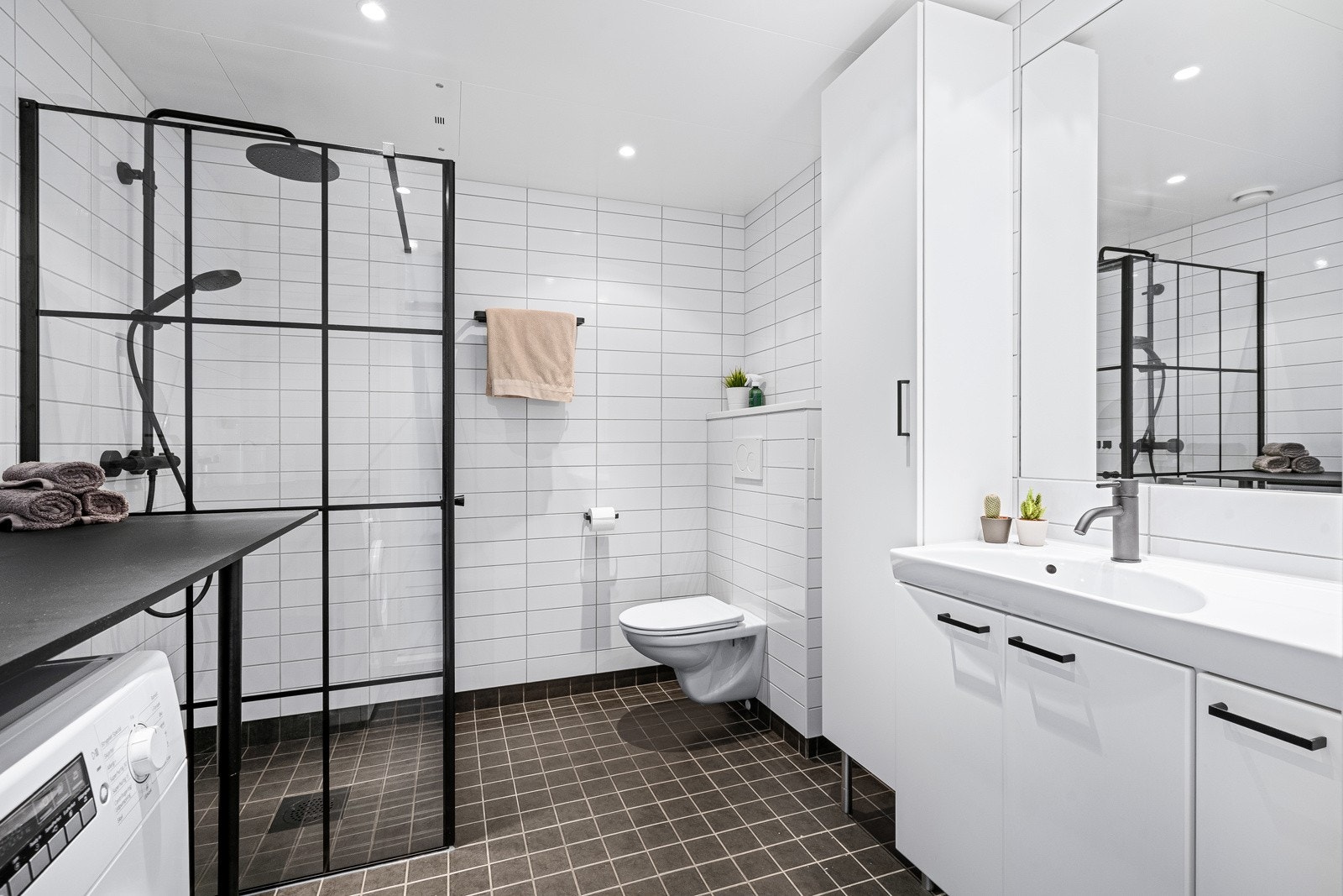 Helfliset bad med tidløse materialvalg og opplegg for vask/tørk Galleribilde