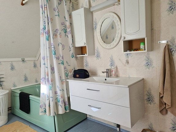 Bad med badekar, dusj, vaskemaskin, toilett Galleribilde