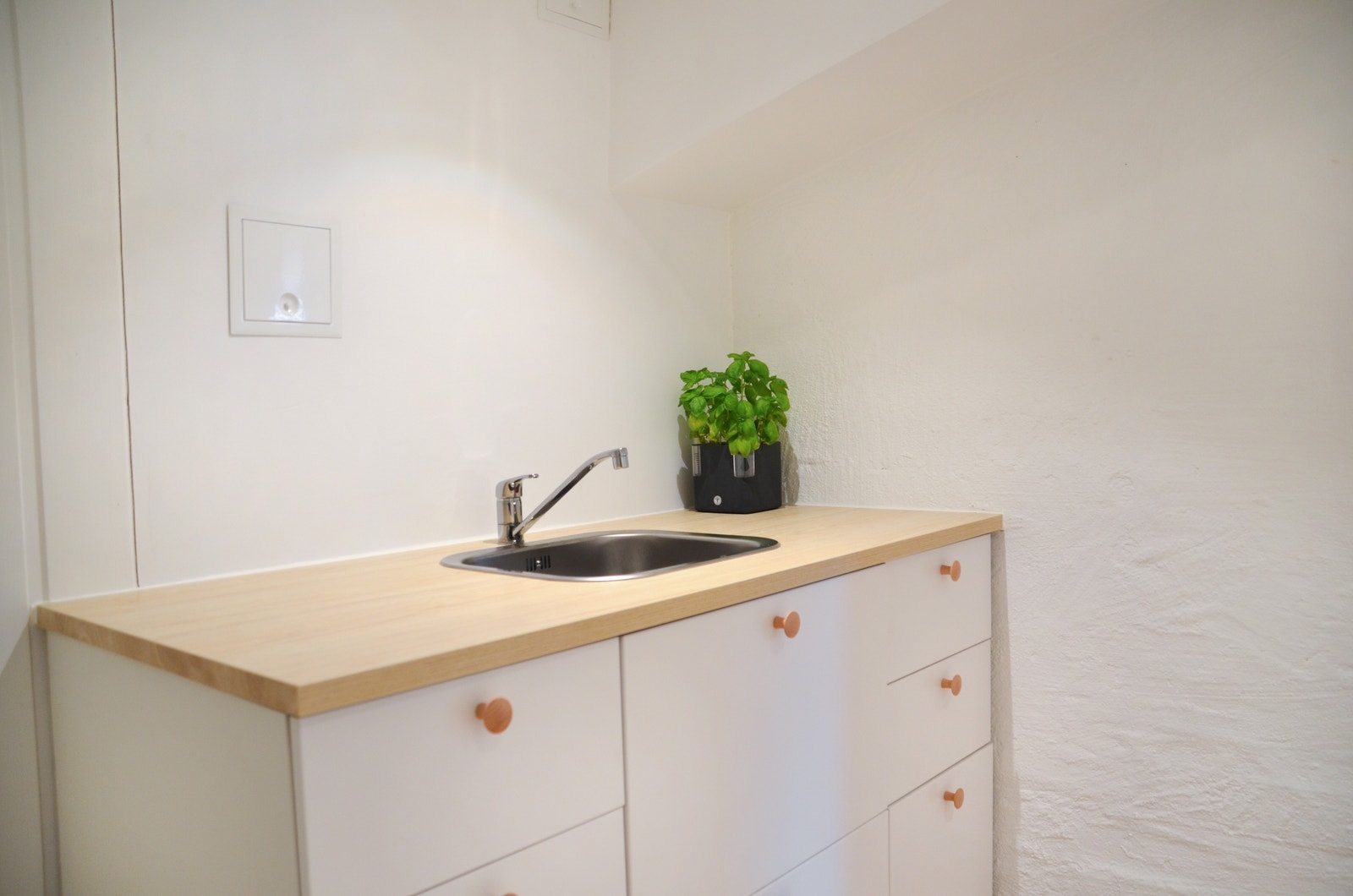 Nyoppusset kjøkken med innredning fra Ikea med kjøleskap-fryser og plass til komfyr. Galleribilde