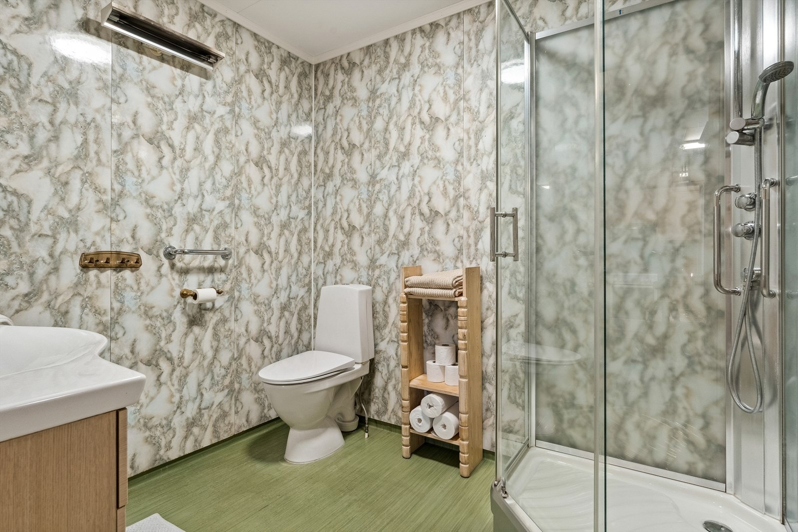 Det er nyere baderomsinnredning med heldekkende servant og overskap, dusjkabinett og gulvmontert wc. På vaskerommet er det stålkum og opplegg for vaskemaskin. Galleribilde