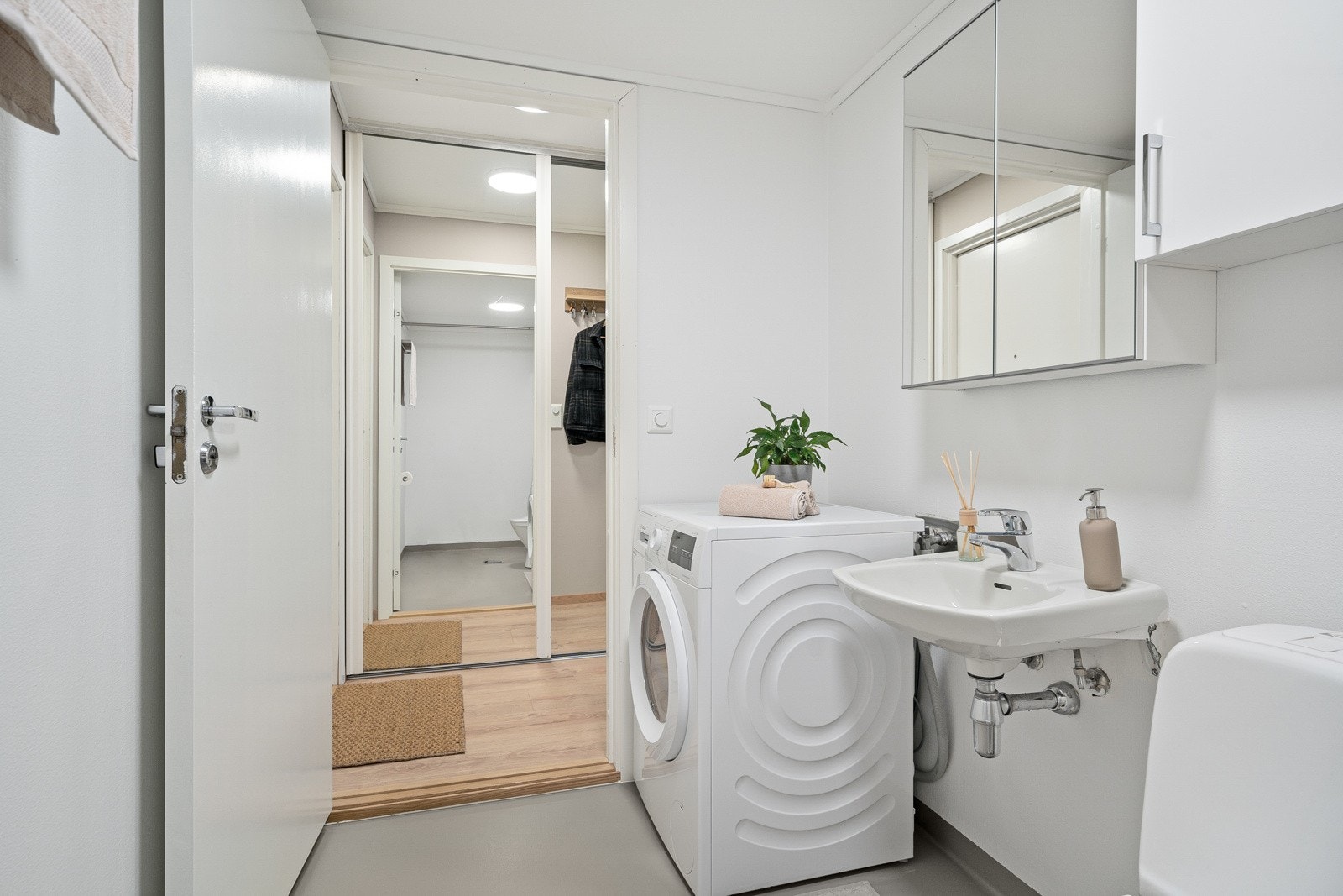 Badet har opplegg for vaskemaskin og ett dusjhjørne med forheng. Galleribilde