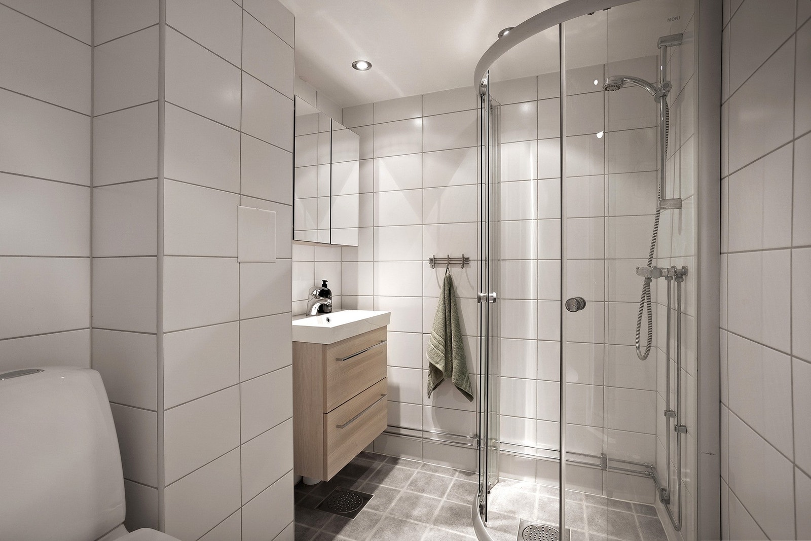 Lyst og pent, flislagt baderom med varme i gulv og downlightsbelysning i taket. Badet ble pusset opp i regi av borettslaget i 2011. Galleribilde