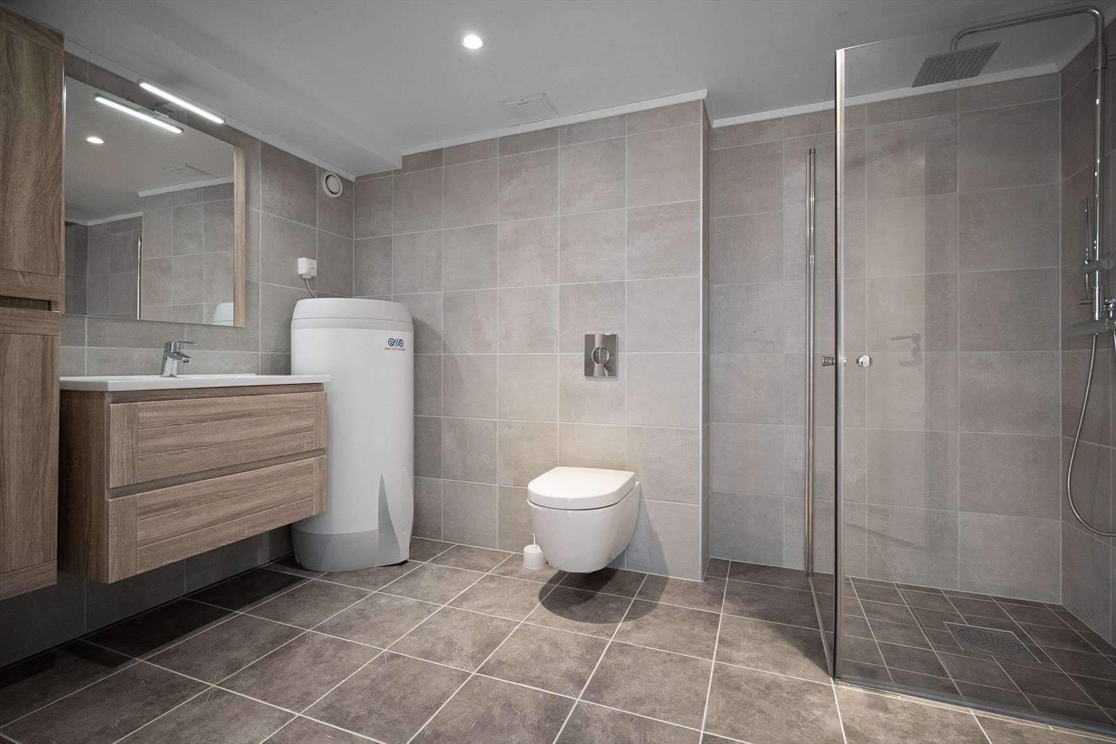 Leiligheten har et pent flislagt baderom som ble pusset opp i 2022. Baderommet har fliser på gulv og vegger, deilig gulvvarme, downlights i himlingen og avtrekksvifte. Galleribilde