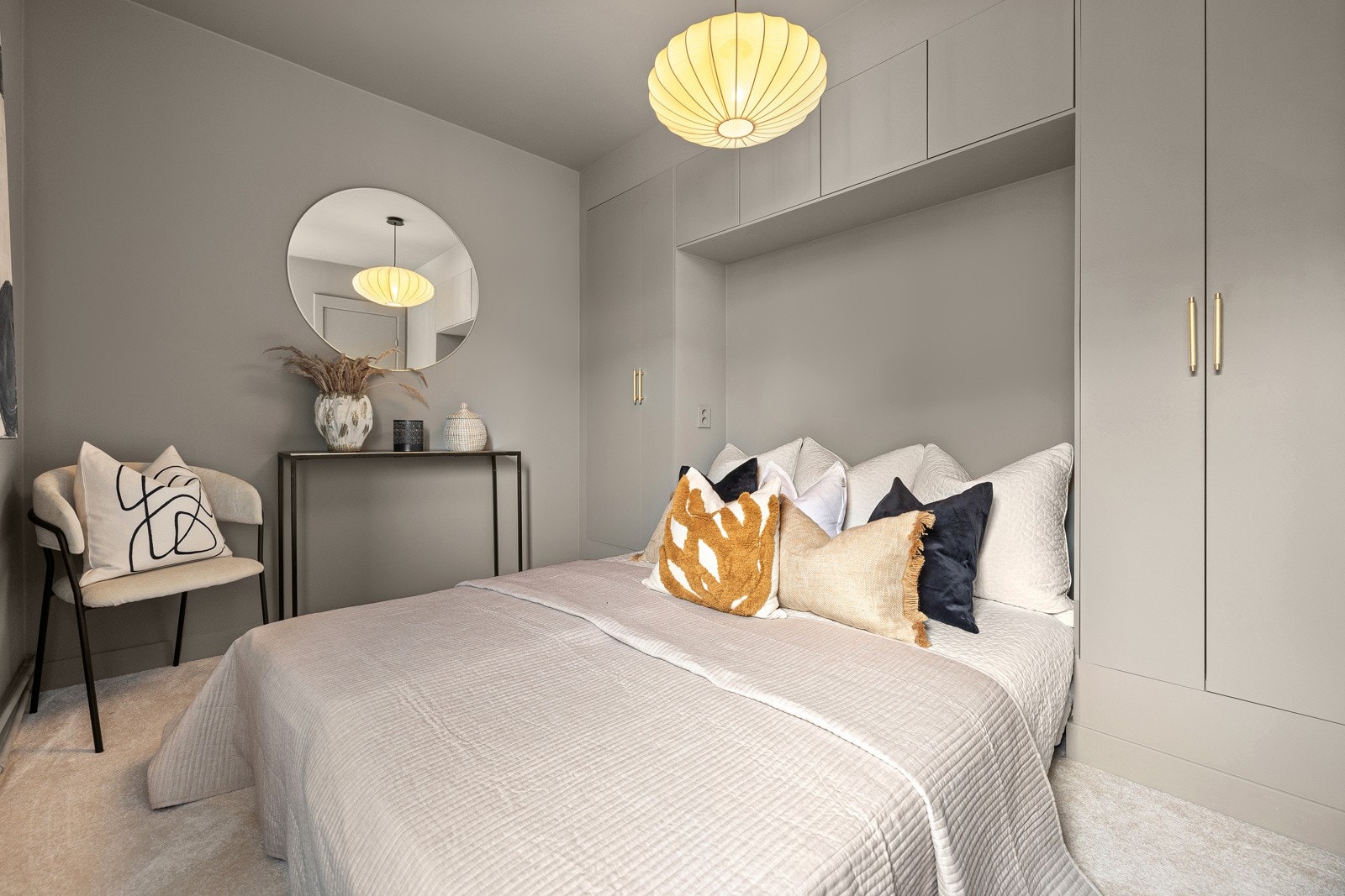 Romslig soverom med lekre, snekkertilpassede garderobeskap som harmonerer med øvrige overflater for et sømløst uttrykk. Galleribilde