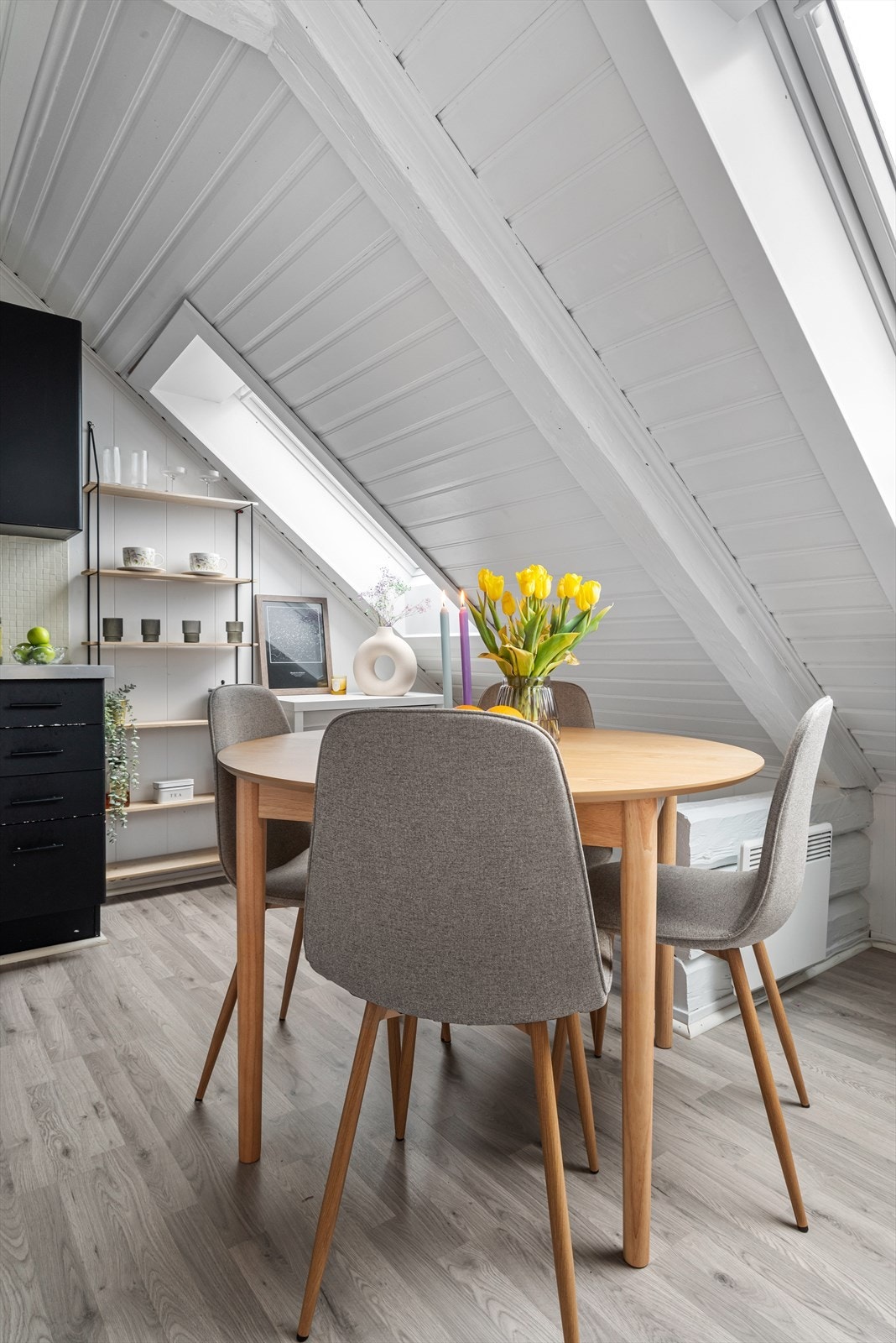 Midt mellom stuen og kjøkkenet er det plass til et lite spisebord. Galleribilde