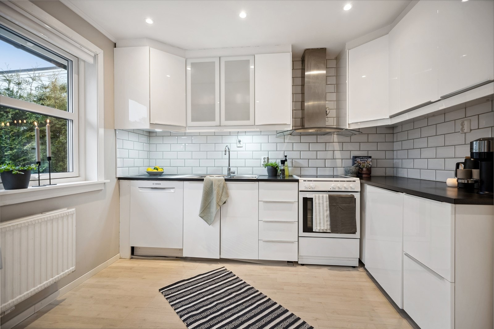 Separat kjøkken med en tidløs kjøkkeninnredning fra IKEA som tilbyr godt med arbeidsplass og oppbevaringsrom. Galleribilde