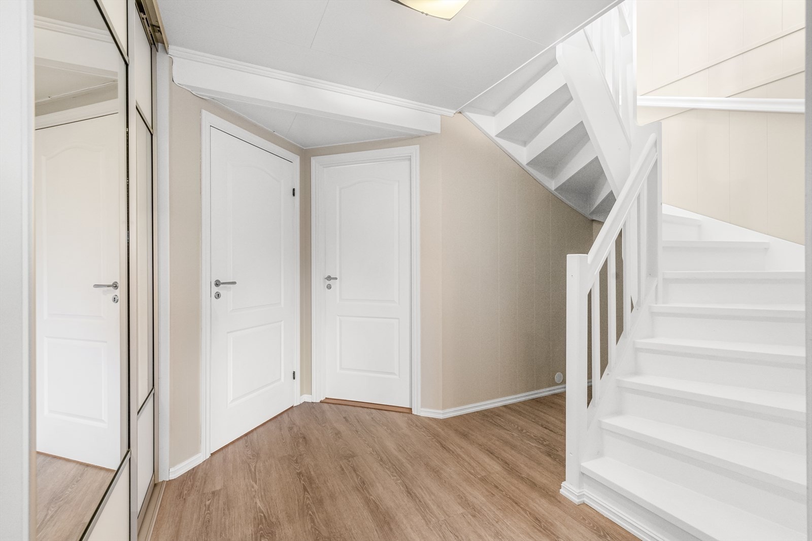 I hallen ryddes yttertøyet enkelt bort i et nyere kott og i en stor, plassbygget skyvedørsgarderobe med dels speilfronter. Galleribilde