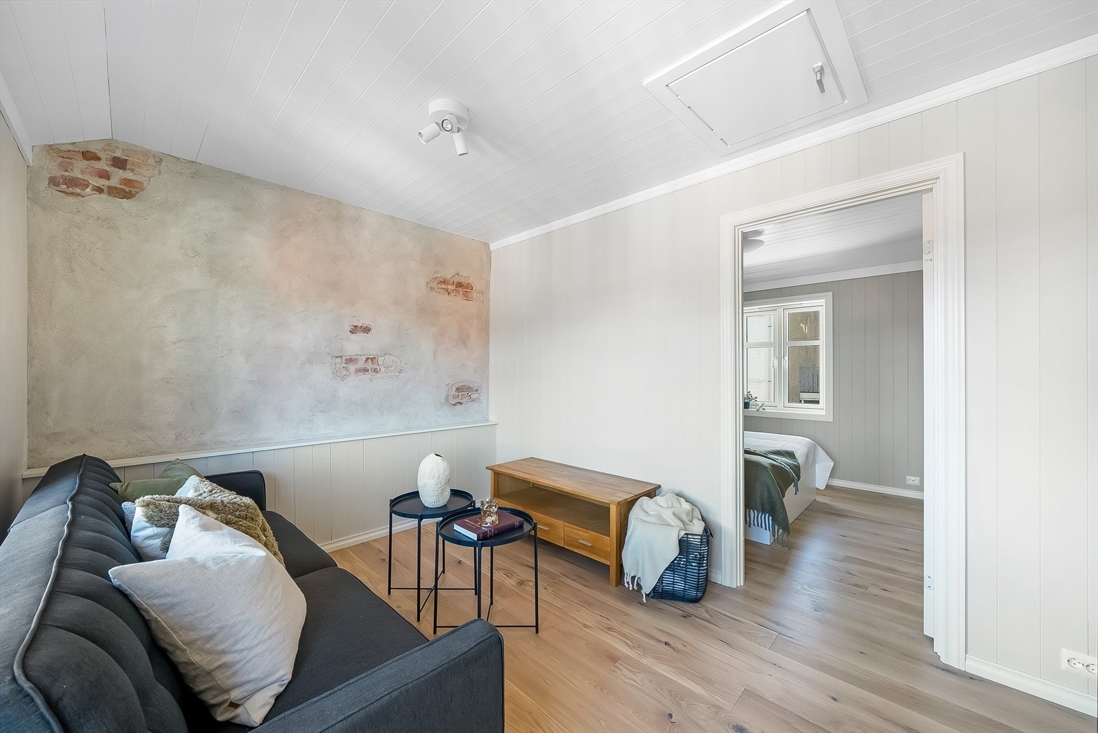 Loftstue med innslag av den originale brannmuren mellom byggene. Galleribilde