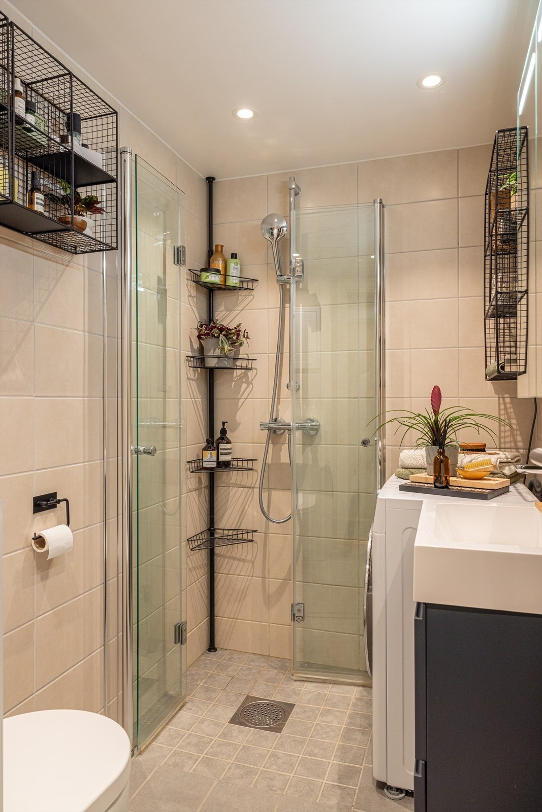 Flott bad fra 2021 med flislagt gulv og vegger, samt dusjhjørne og downlights i tak Galleribilde