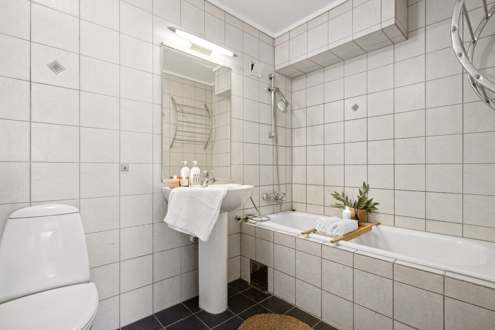 Baderom og vaskerom ligger vegg i vegg, totalt 7 m² med våtrom. Badet er flislagt og har varmekabler i gulv. Galleribilde