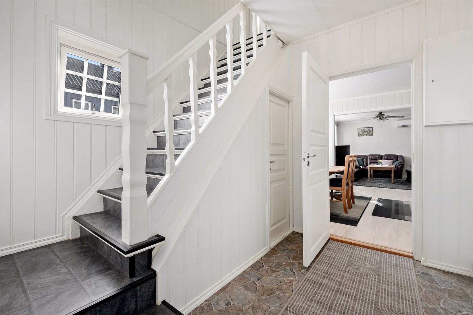 Takoverbygd inngangsparti med betongtrapp langs røstvegg fører deg inn i entrè/ trapperom. Galleribilde