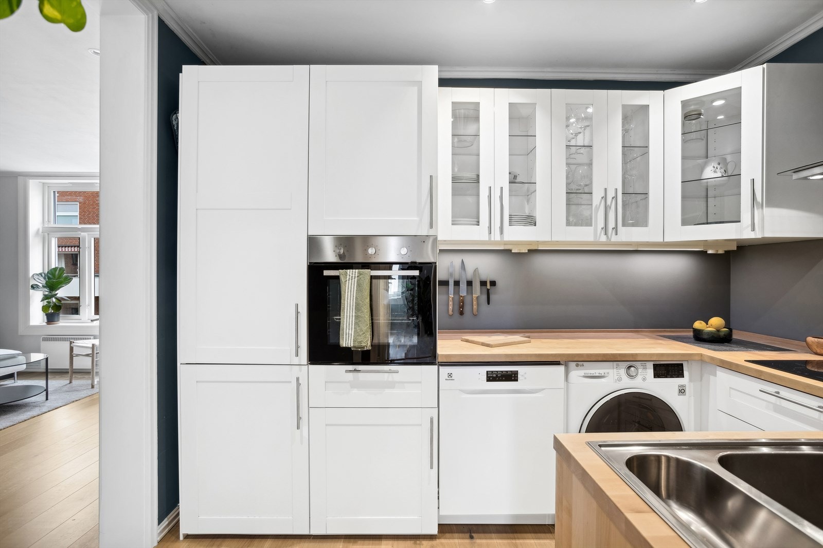 Kjøkkenet har integrerte hvitevarer som kjøl/frys, stekeovn i høyskap og platetopp samt veggmontert avtrekksvifte. Det er opplegg for både vaskemaskin og oppvaskmaskin. Galleribilde