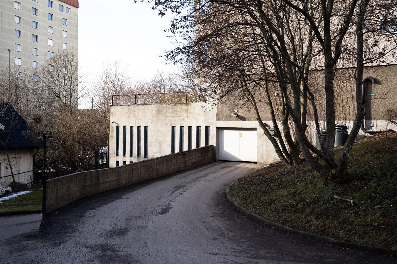Innkjøring til garasjeanlegg. Borettslaget har også egen gjesteparkering på eget området på fremsiden av bygget. Galleribilde