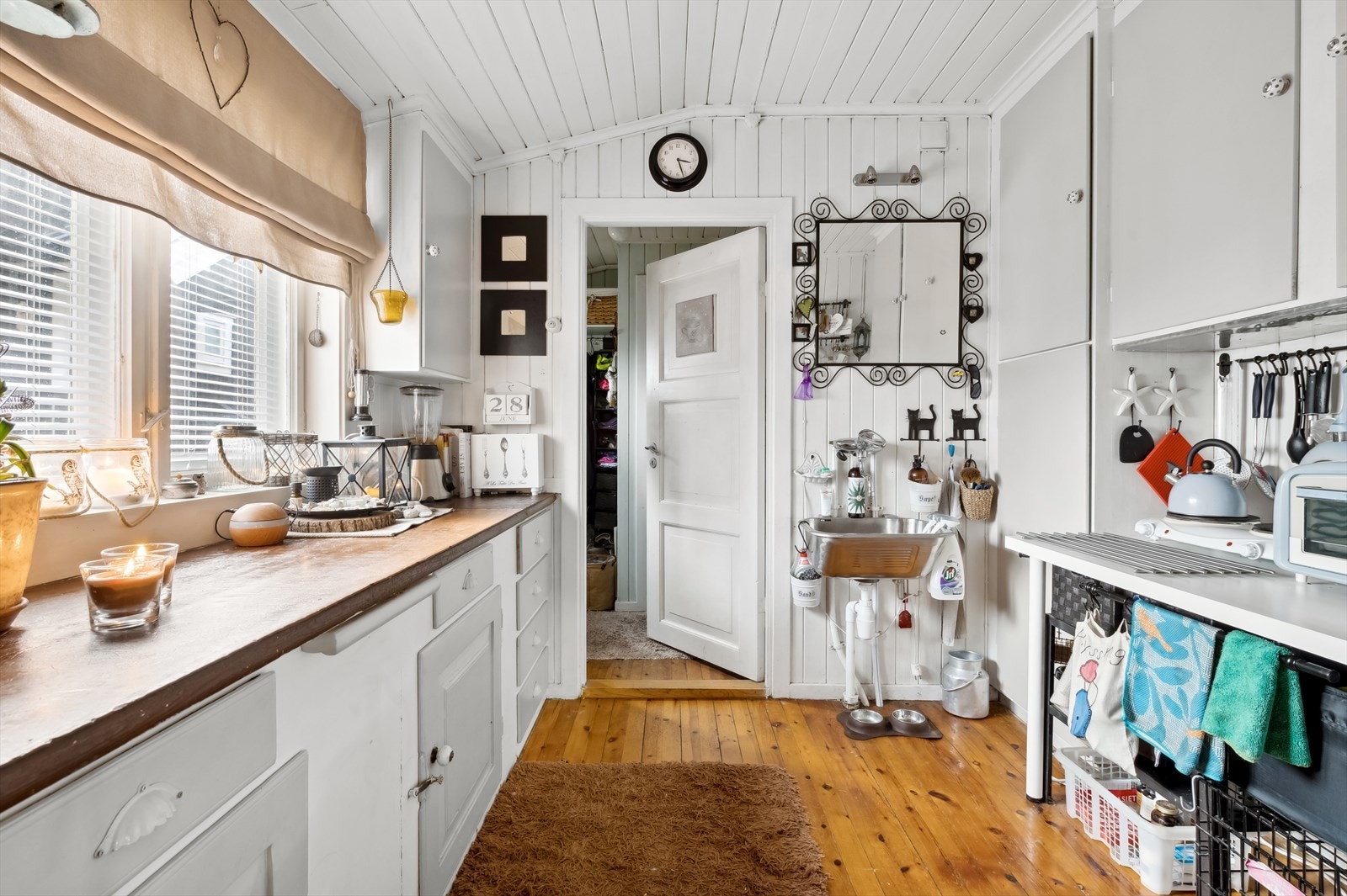 Inneholder et kjøkken, med vv-bereder i en kjeller under kjøkkenet. Galleribilde