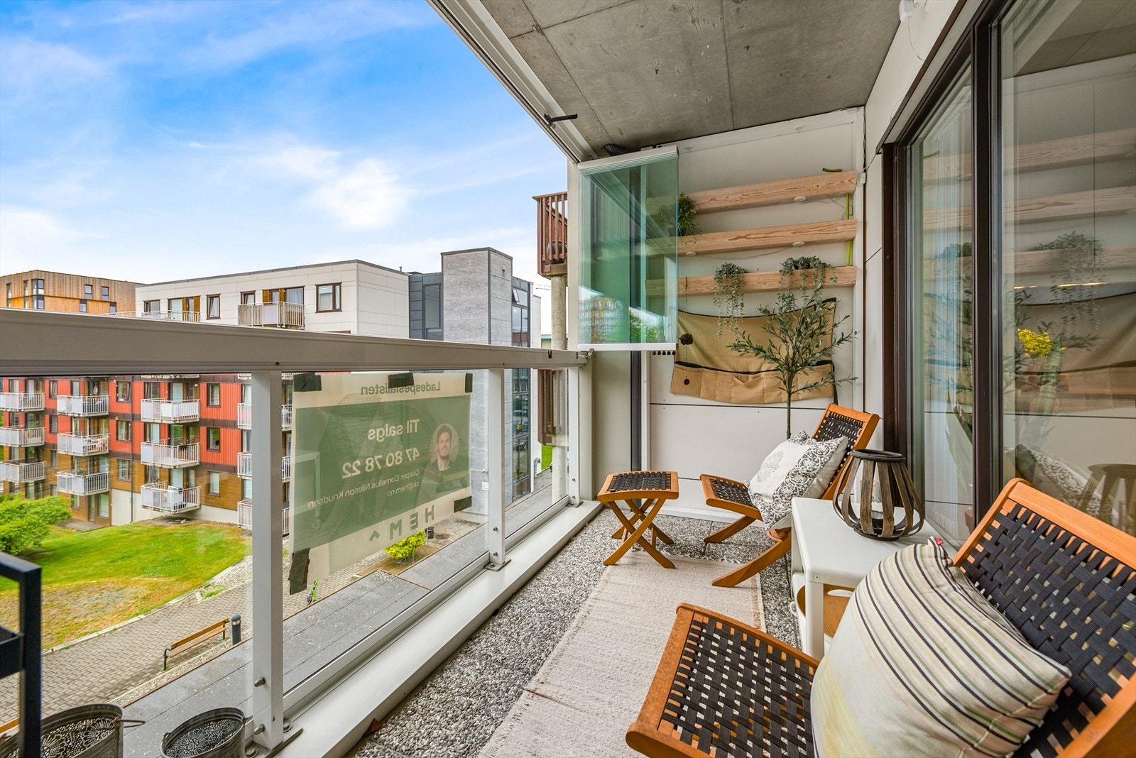 Balkongen er solrik og delvis innglasset. Galleribilde