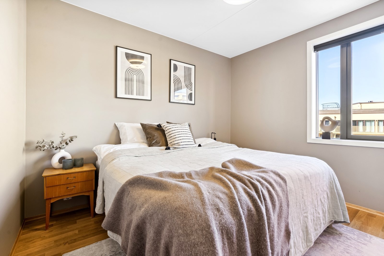 Stilfullt soverom med rikelig dagslys og behagelige fargetoner. Galleribilde