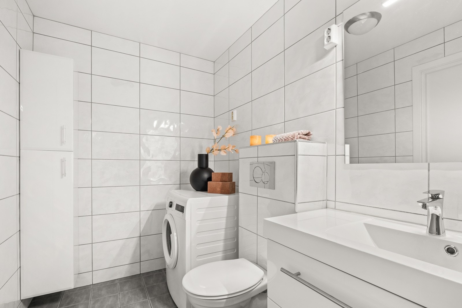 Praktisk baderom med opplegg til vaskemaskin og skapplass Galleribilde