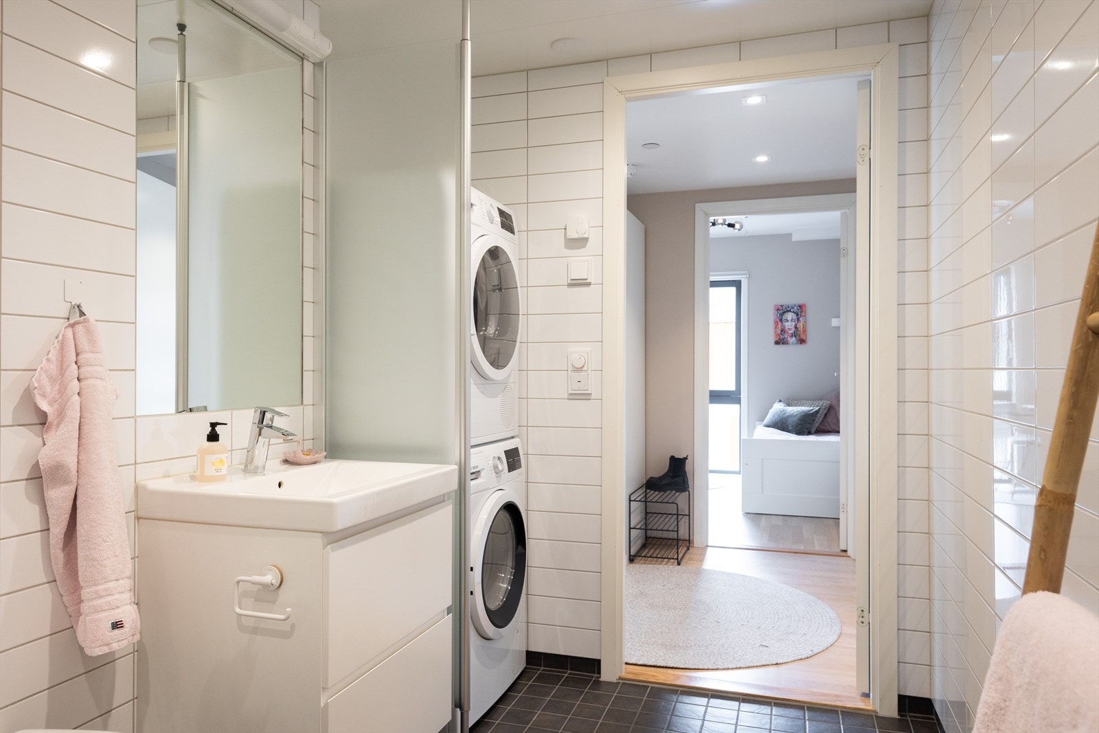 Badet er innredet med vegghengt toalett, servant med innredning og dusjhjørne med innfellbare glassdører. Galleribilde