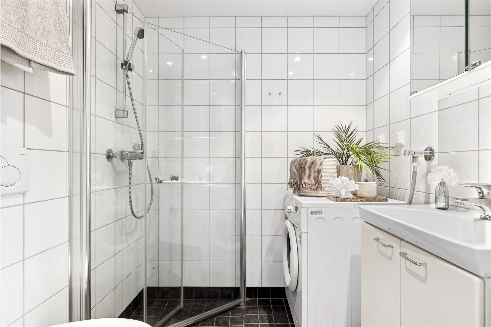 Badet har et vegghengt toalett, innsvingbare dusjdører, et servantskap og et speilskap for oppbevaring. Både gulv og vegger er flislagt. Taket har integrerte spotlights, og gulvet har varmekabler for økt komfort. Galleribilde