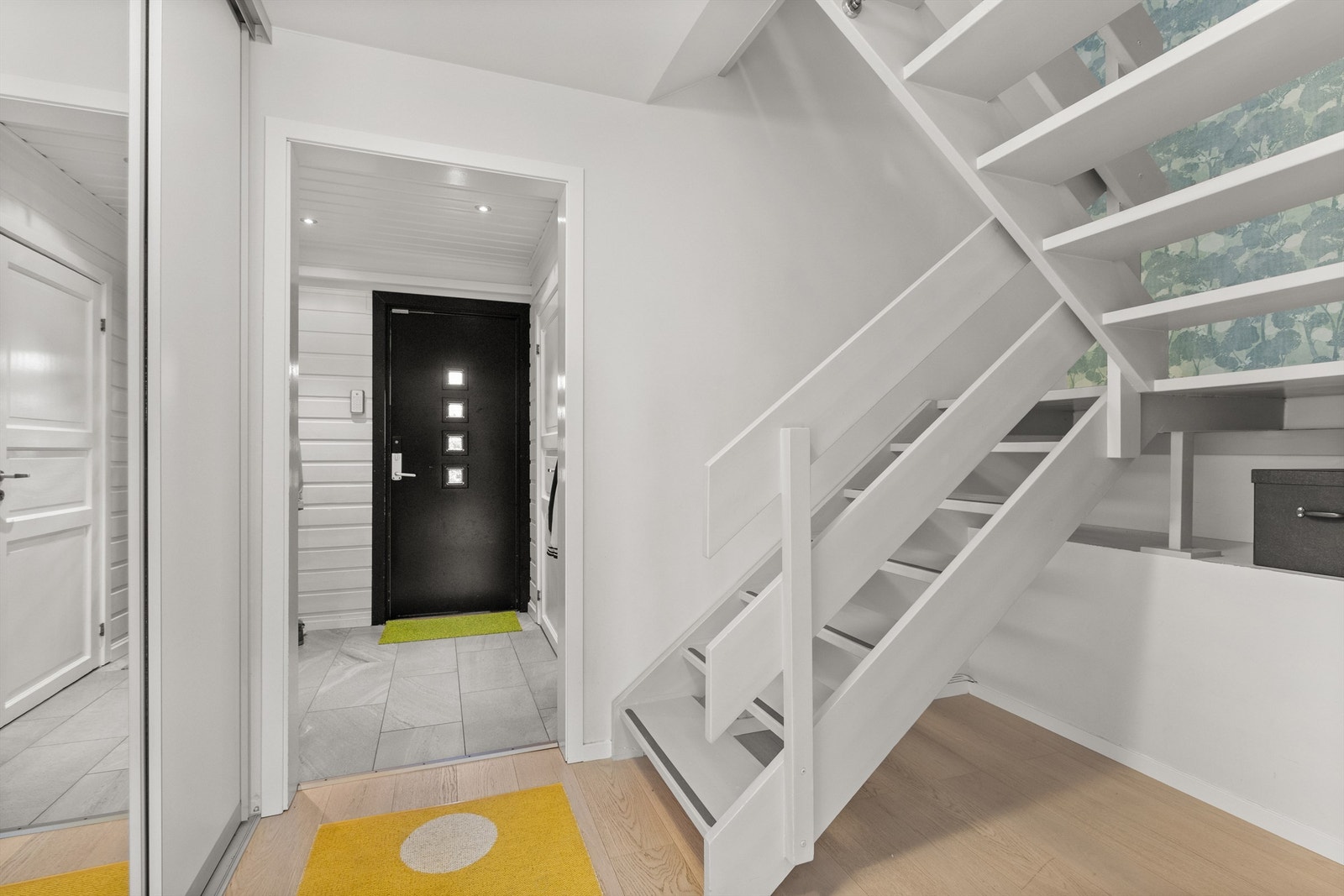 Hallen har 1-stavs parkett på gulvet og praktisk skyvedørsgarderobe Galleribilde