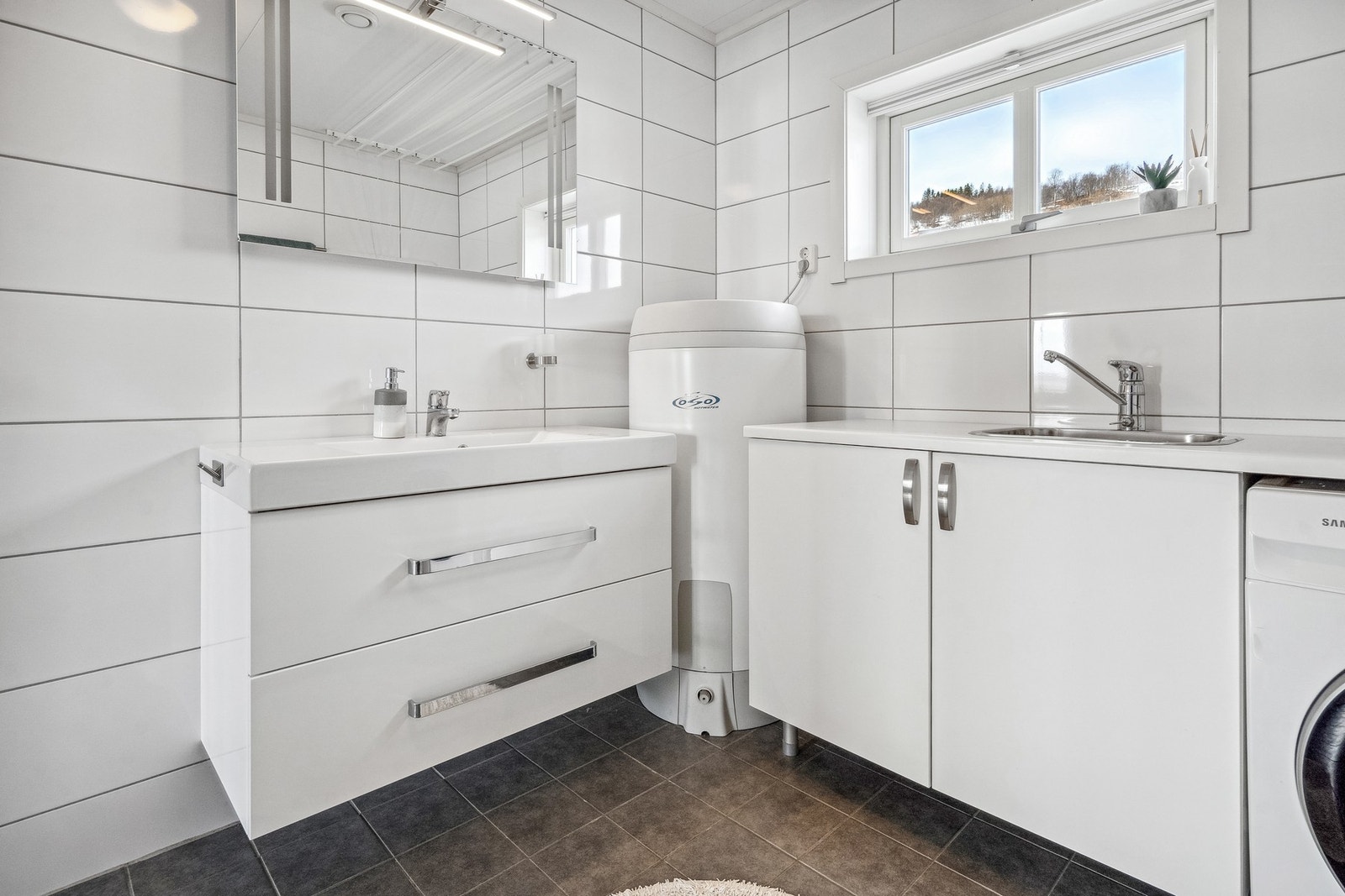 Vegghengt baderomsinnredning og gode oppbevaringsmuligheter i utslagsvask. Galleribilde