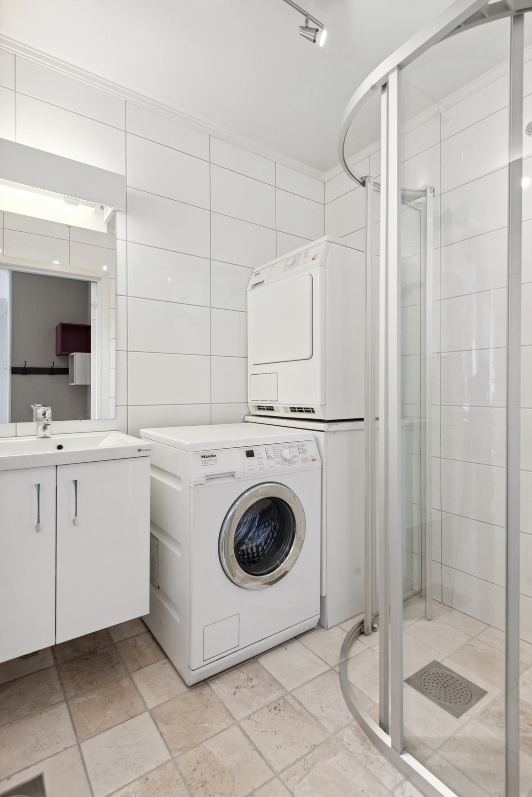 Badet har opplegg for vaskemaskin og tørketrommel. Dusjhjørne med buede dusjvegger. Galleribilde