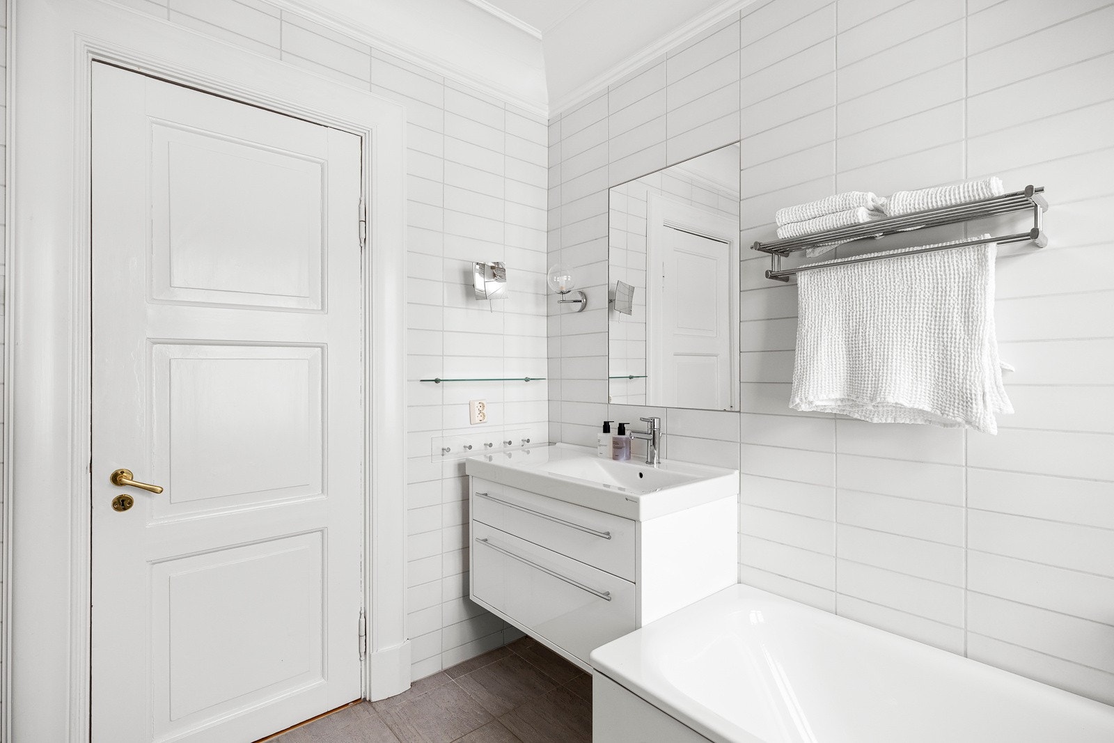 Her er det hvite fliser på veggene og grå fliser på gulv med gulvvarme. Galleribilde