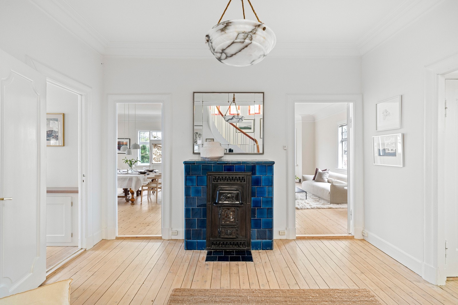 Kaminen er kledd med blå, glasserte fliser. Galleribilde