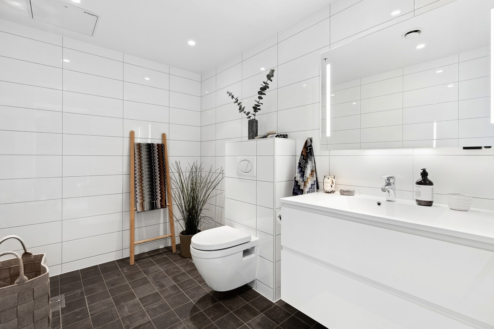 Badet har stilren og moderne baderomsinnredning, og rommets gode størrelse gjør det enkelt å kunne montere et badekar for dem som ønsker det Galleribilde