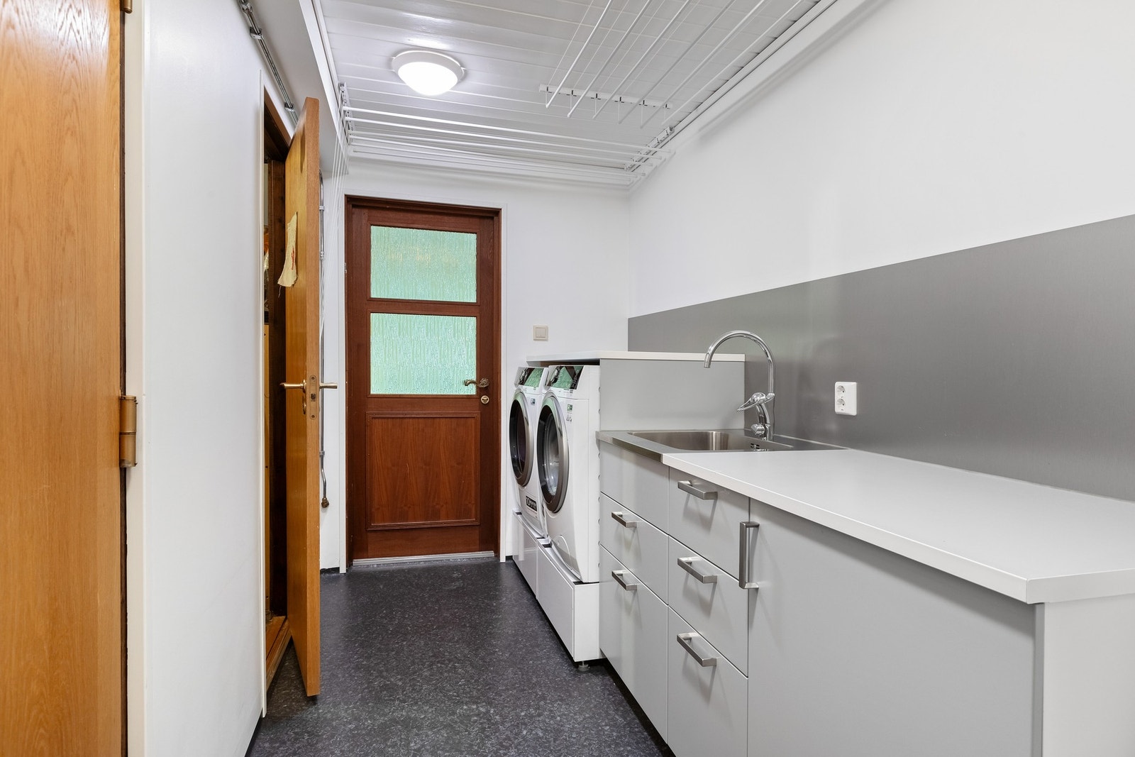 Separat vaskerom med direkte utgang til carport - Gulvvarme, opplegg for vaskemaskin, mekanisk avtrekk, bereder, servantskap og servant. Galleribilde