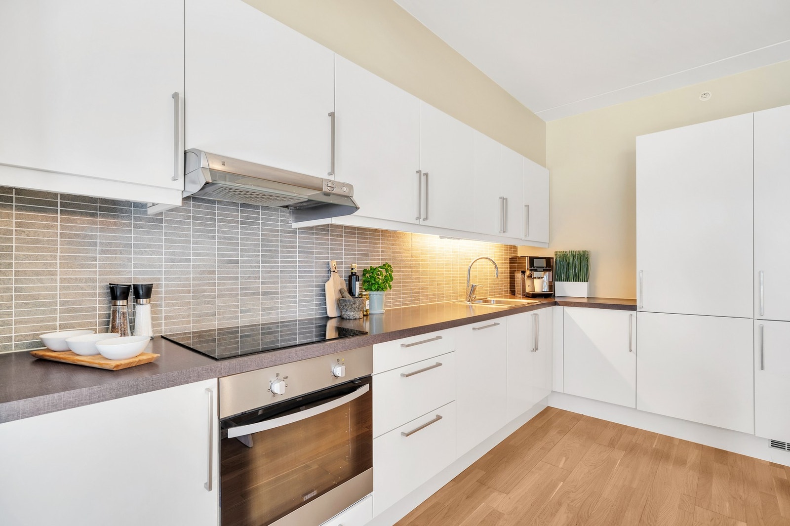 Kvalitetskjøkken fra HTH med integrerte hvitevarer som platetopp, stekeovn, oppvaskmaskin og kjøle/fryseskap. Galleribilde