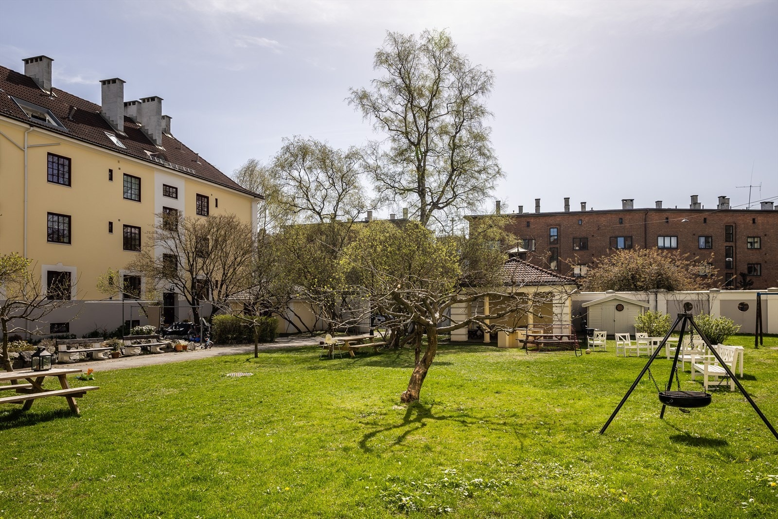 Felles hage med vakre trær og blomster, og flere sittegrupper Galleribilde