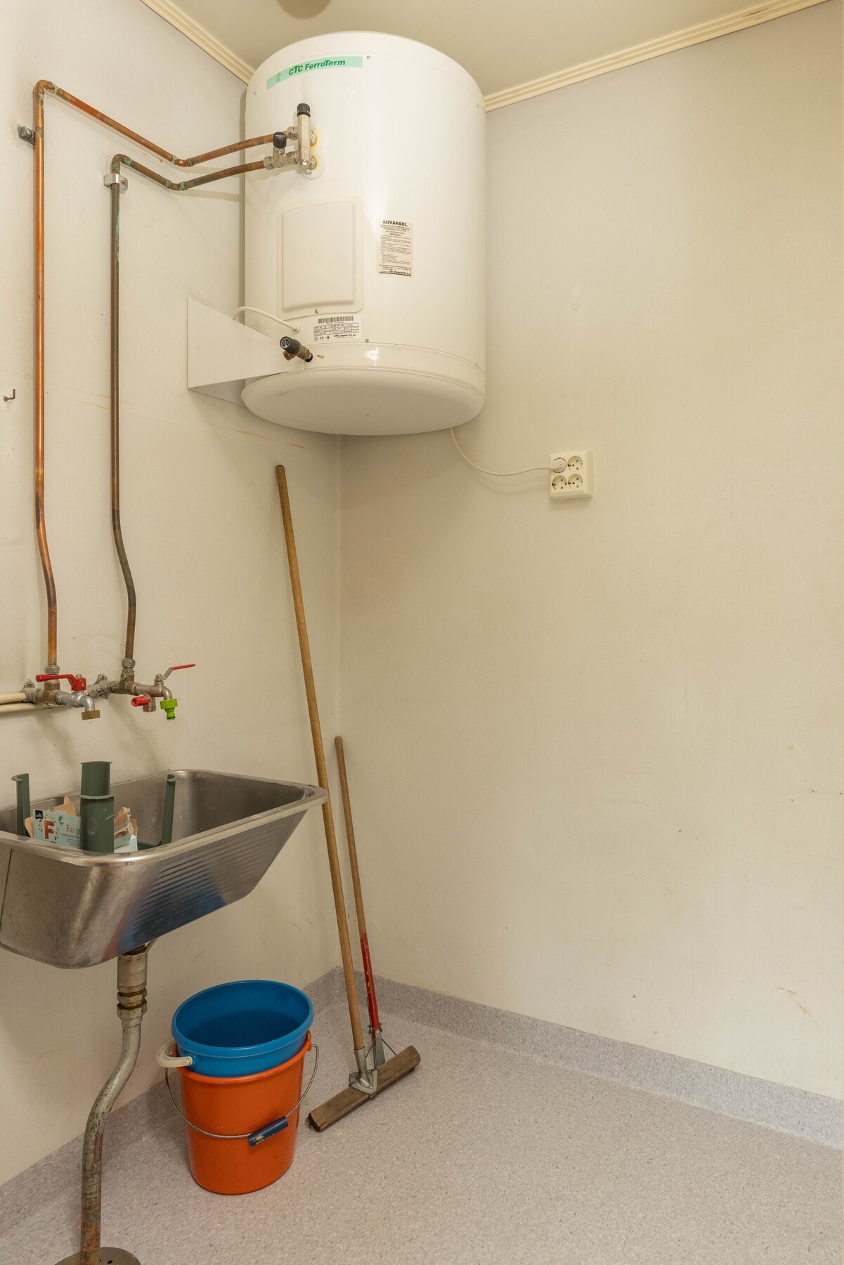 Bak kjøkkenet er det i dag et vaskerom med nytt vinylgulv og nytt sluk i 2022. Galleribilde