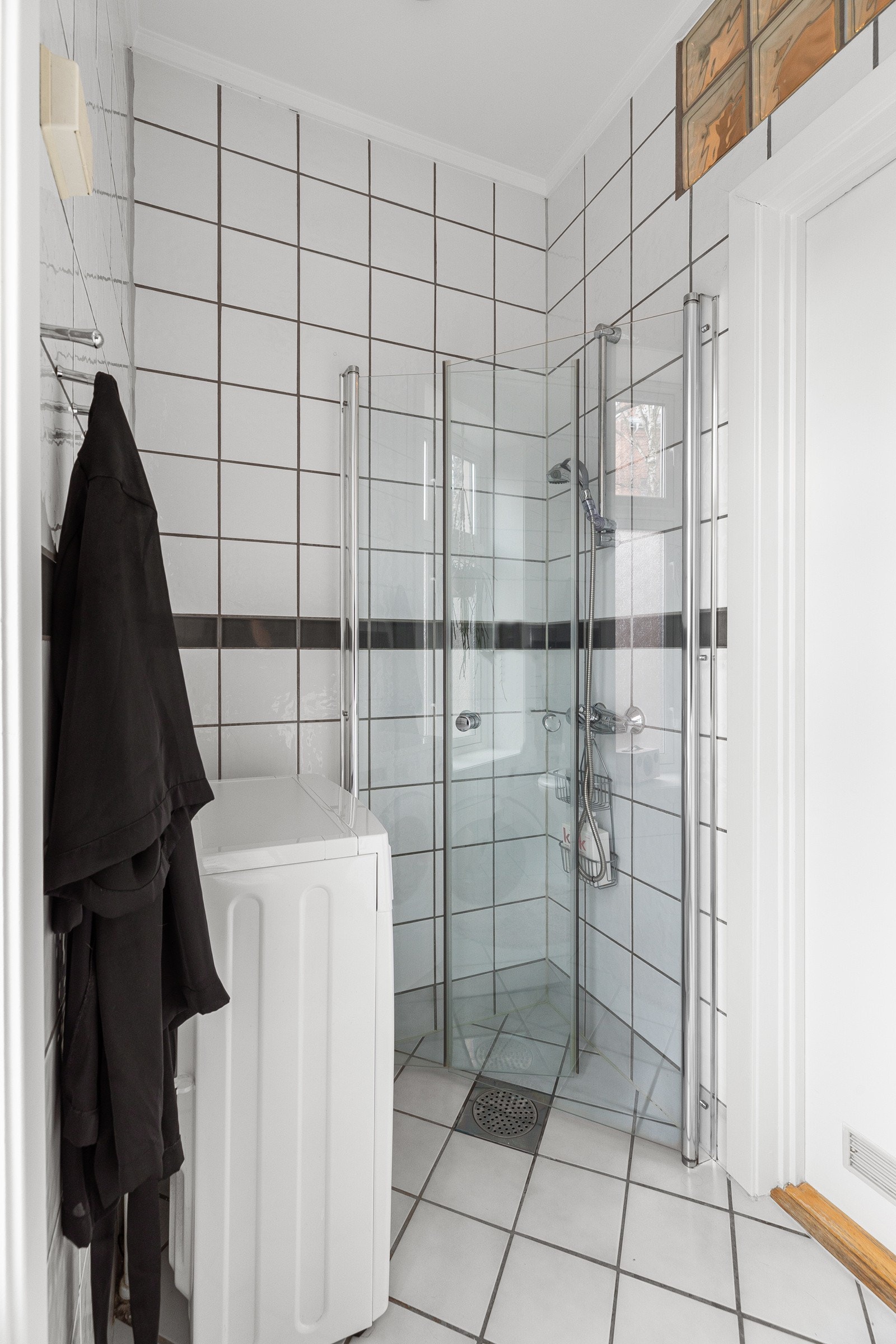 Badet er utstyrt med dusj med svingbare dusjvegger og et termostatstyrt dusjbatteri i krom, inkludert en hånddusj Galleribilde
