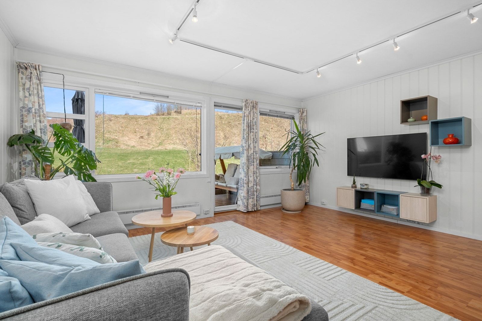 En stor vindusflate sørger for godt med naturlig lys, samtidig som den bringer inn noe av det grønne. Galleribilde