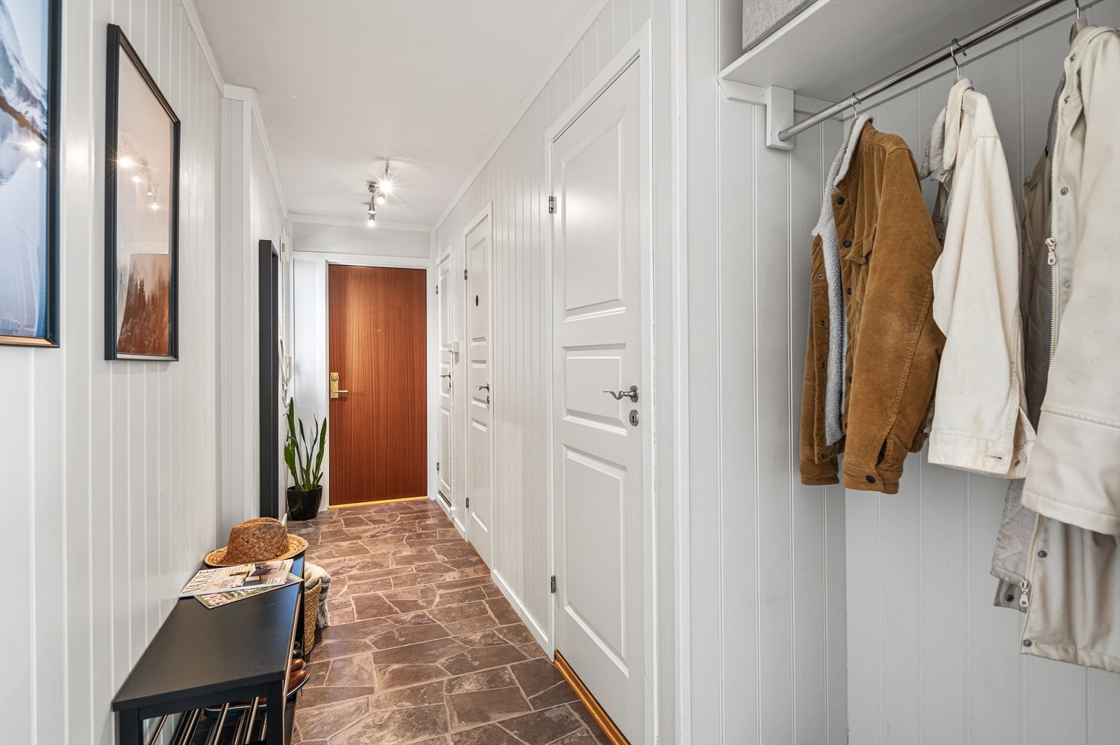 Man kommer inn til en lys og stor entré med god plass til garderobeskap eller kommode for oppbevaring av ytterklær og sko. De nøytrale fargevalgene er gjennomgående i hele leiligheten og gjør det enkelt å sette sitt eget preg på interiøret. Galleribilde