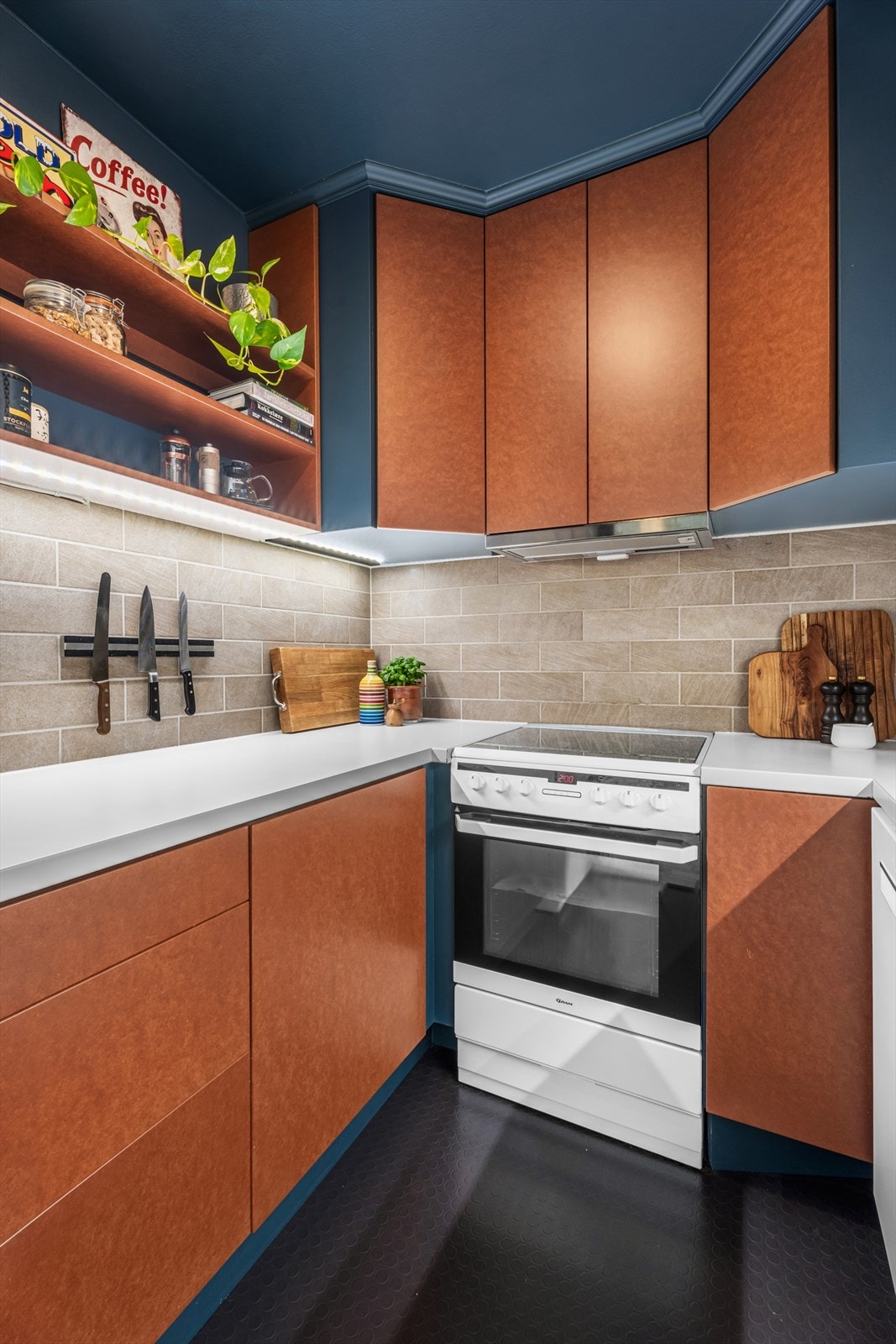 På kjøkkenet er det en lys laminert benkeplate med integrert kum, glatte fronter og fliser på vegg. Galleribilde