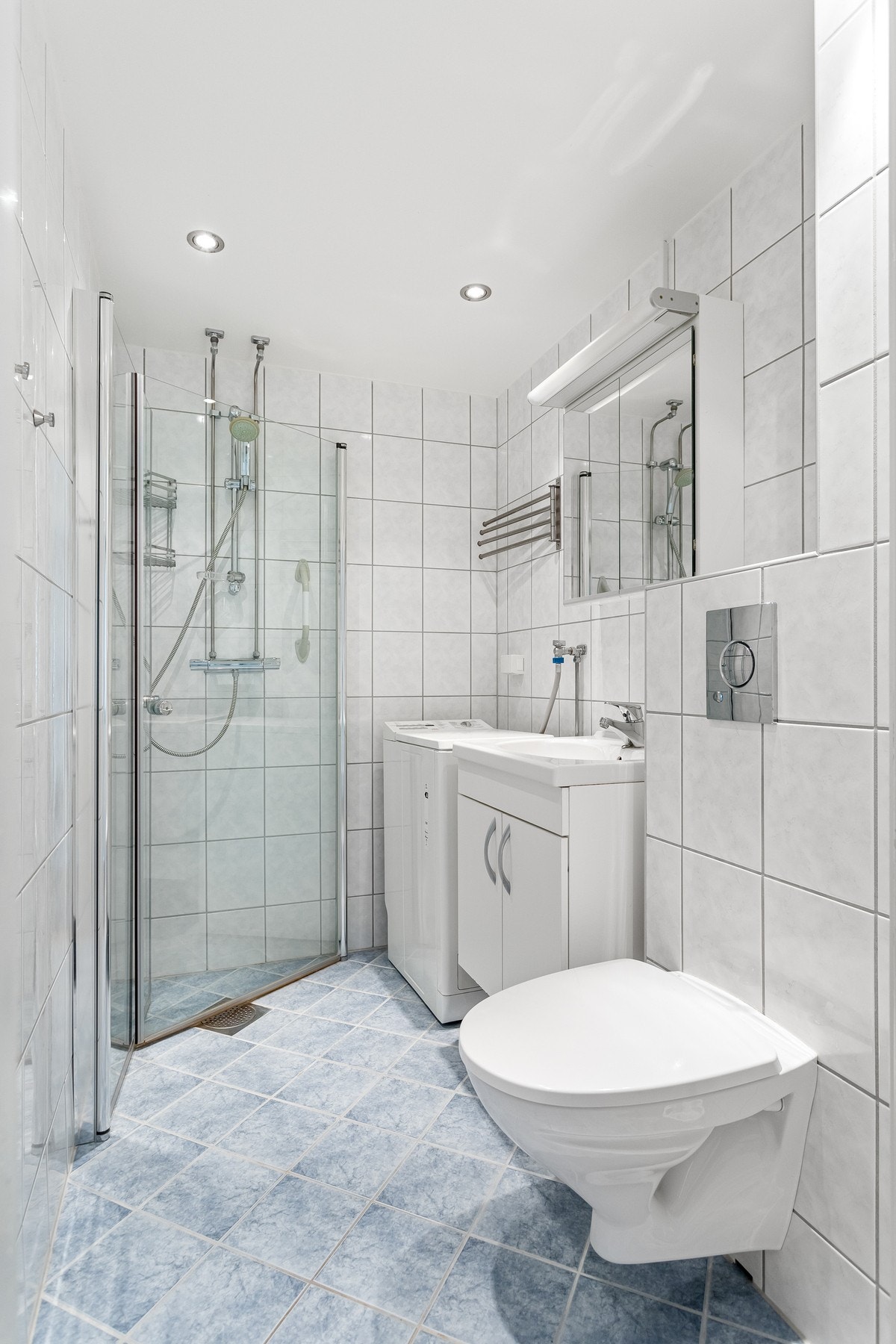 Rommet er utstyrt med innredning med nedfelt servant, veggmontert toalett og dusjvegger/hjørne. Det er opplegg for vaskemaskin på badet. Galleribilde