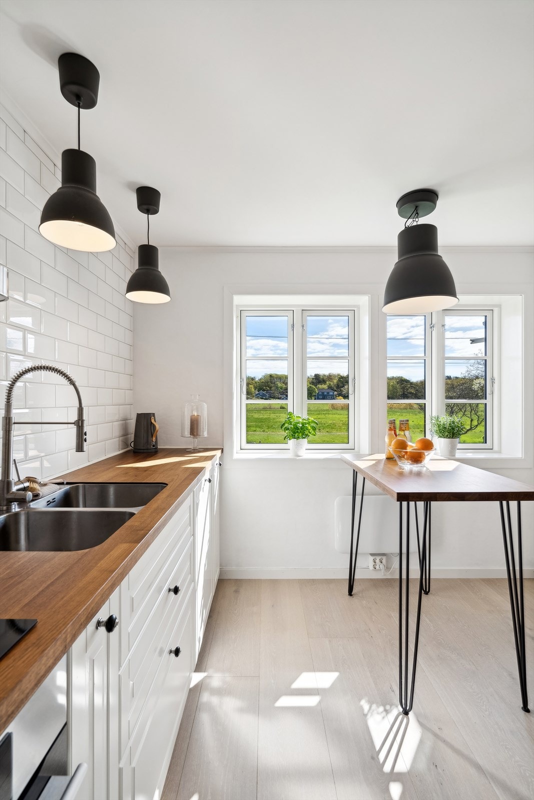 Tiltalende og velutstyrt kjøkken (2021), innredning med malt utførelse. Benkeplate i valnøtt/finer med nedfelt benkebeslag og to kummer. Galleribilde