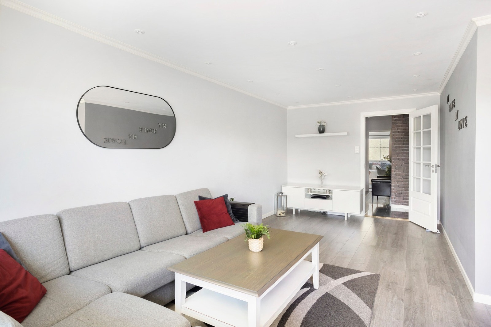 Det er lagt laminat på gulv og overflatene er malt i lyse fargevalg, i tillegg til tapet i teglsteinsdetaljer på en vegg. Galleribilde