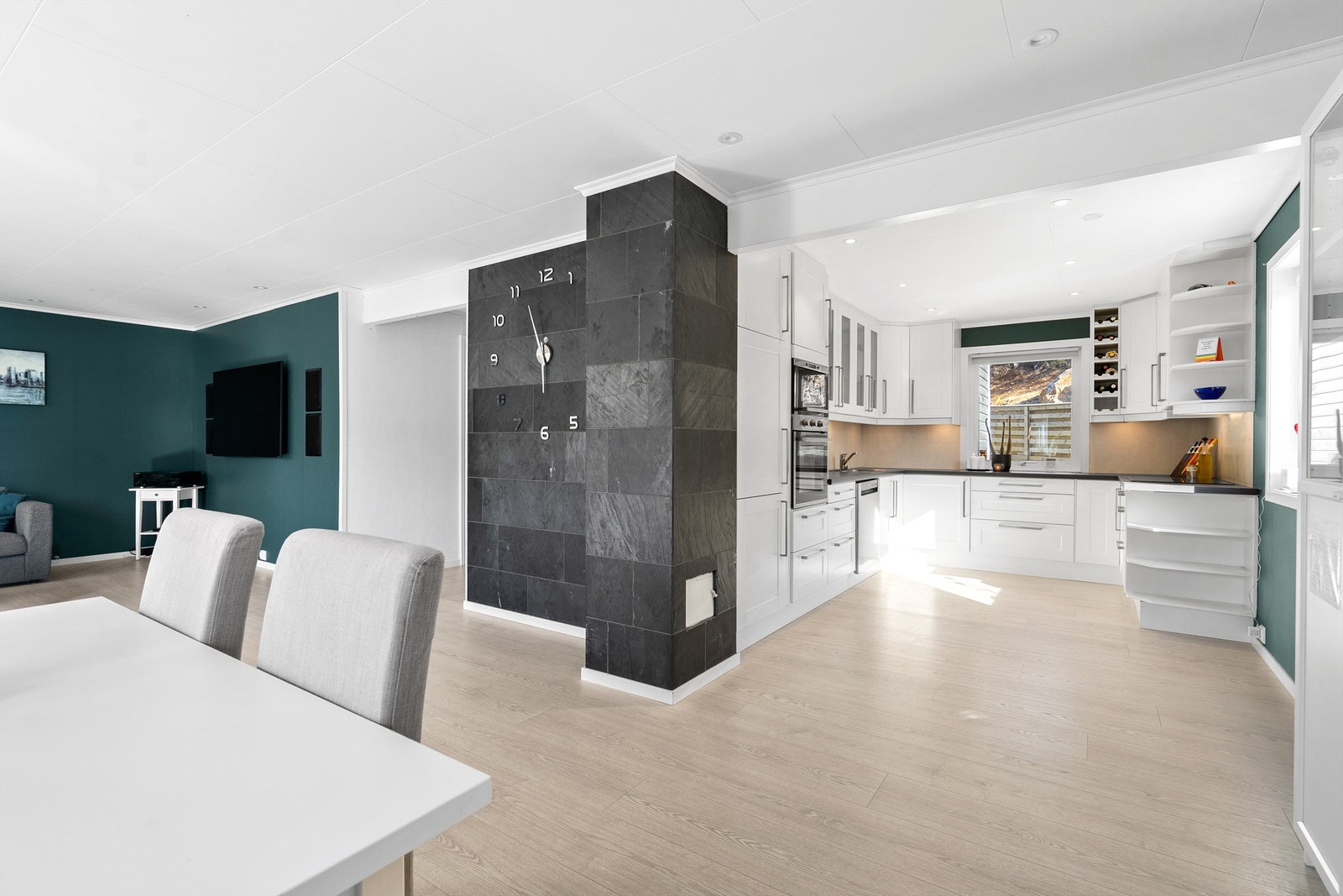 Pent og innbydende kjøkken med åpen løsning til spisestue og stue Galleribilde