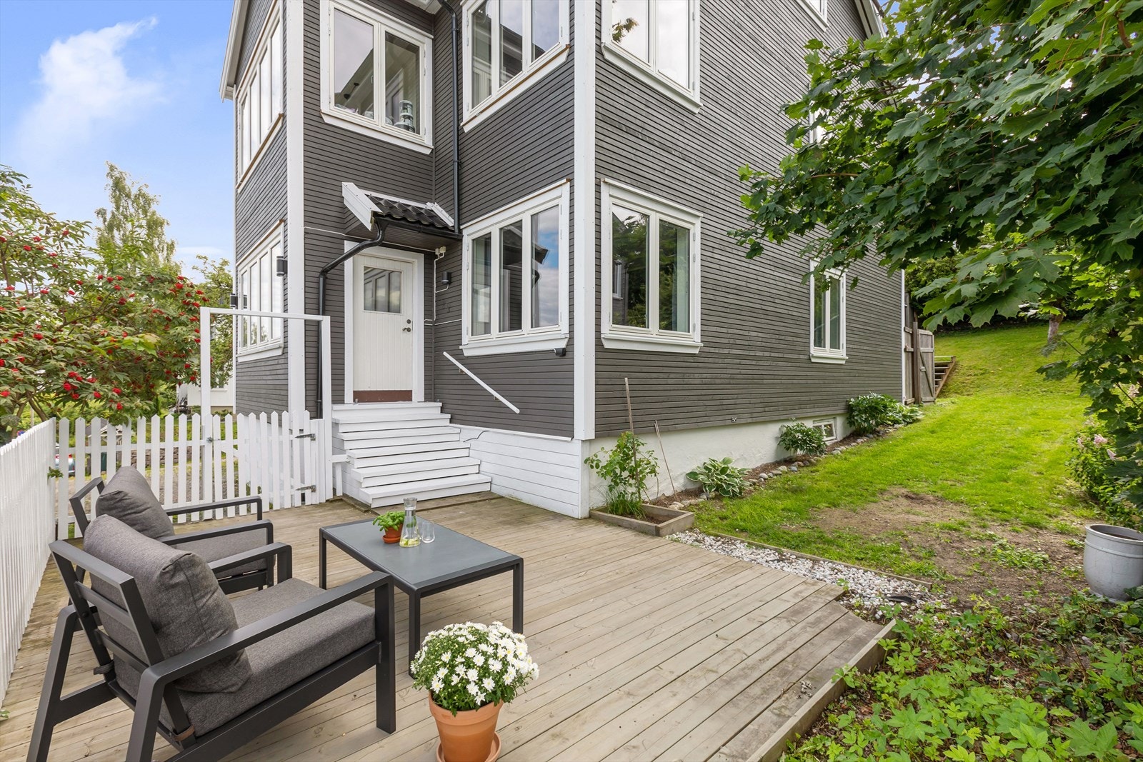 Adkomst til fin uteplass med terrasseplatting og hage (utearealene er felles tomt) Galleribilde