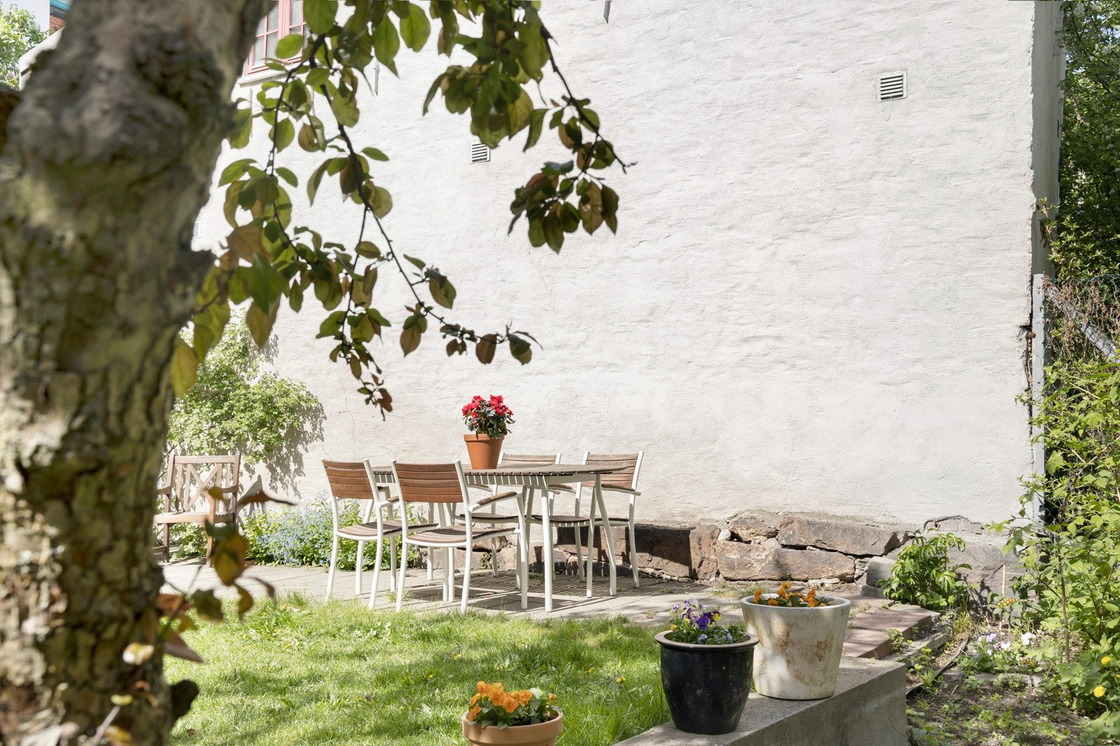 *Frodig bakgård med sittegrupper* Galleribilde