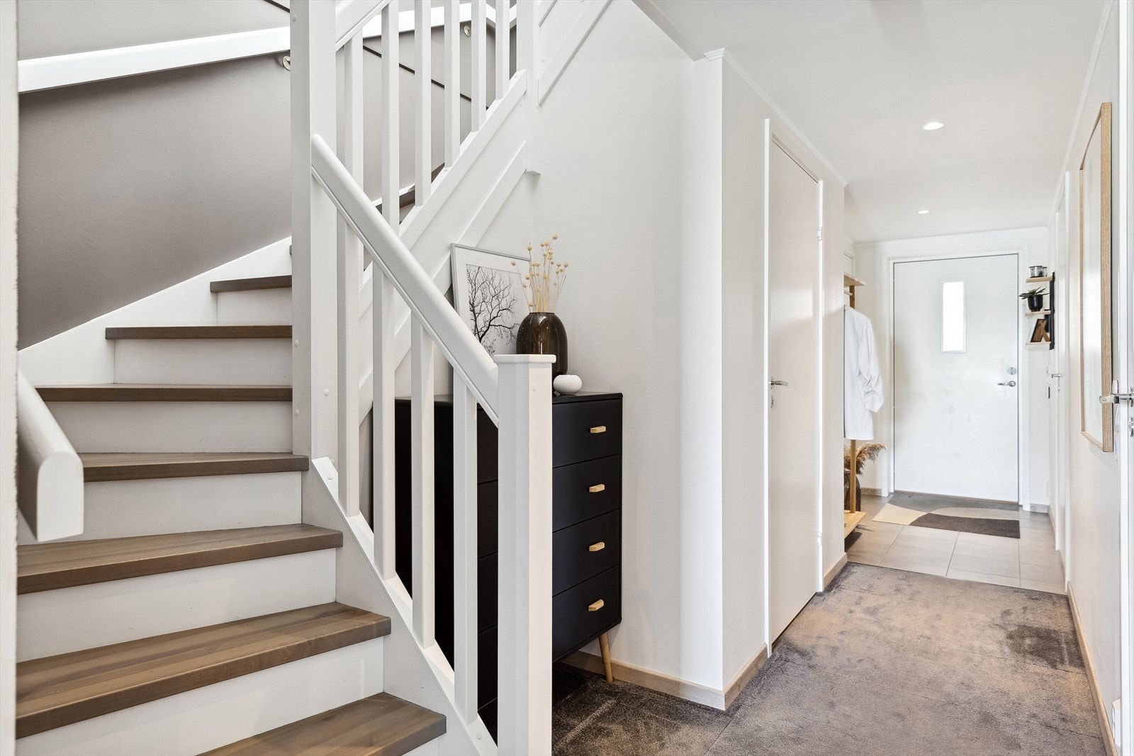 Første etasjen består av gang, tre soverom, bad og wc-rom. Det er lagt et lunt og behagelig teppeflis i deler av gangen. Galleribilde