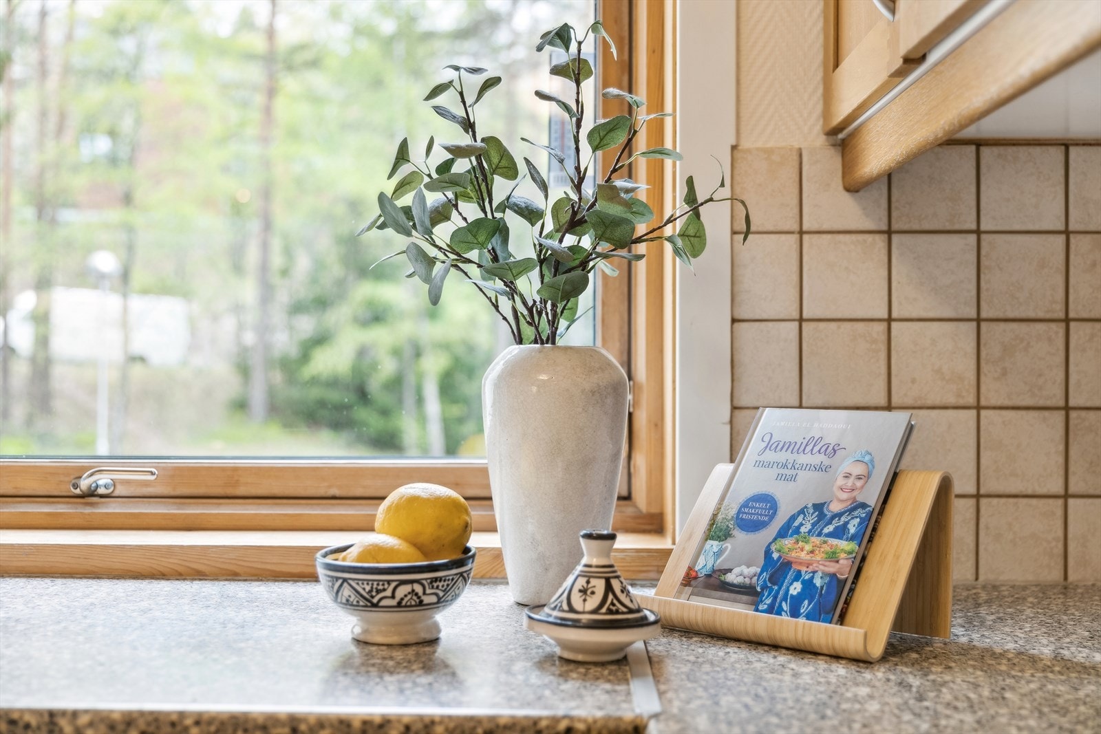Kjøkkenet er innredet med skapdører av tidløs furu og benkeplater av laminat, med flis over benkeplaten. Galleribilde