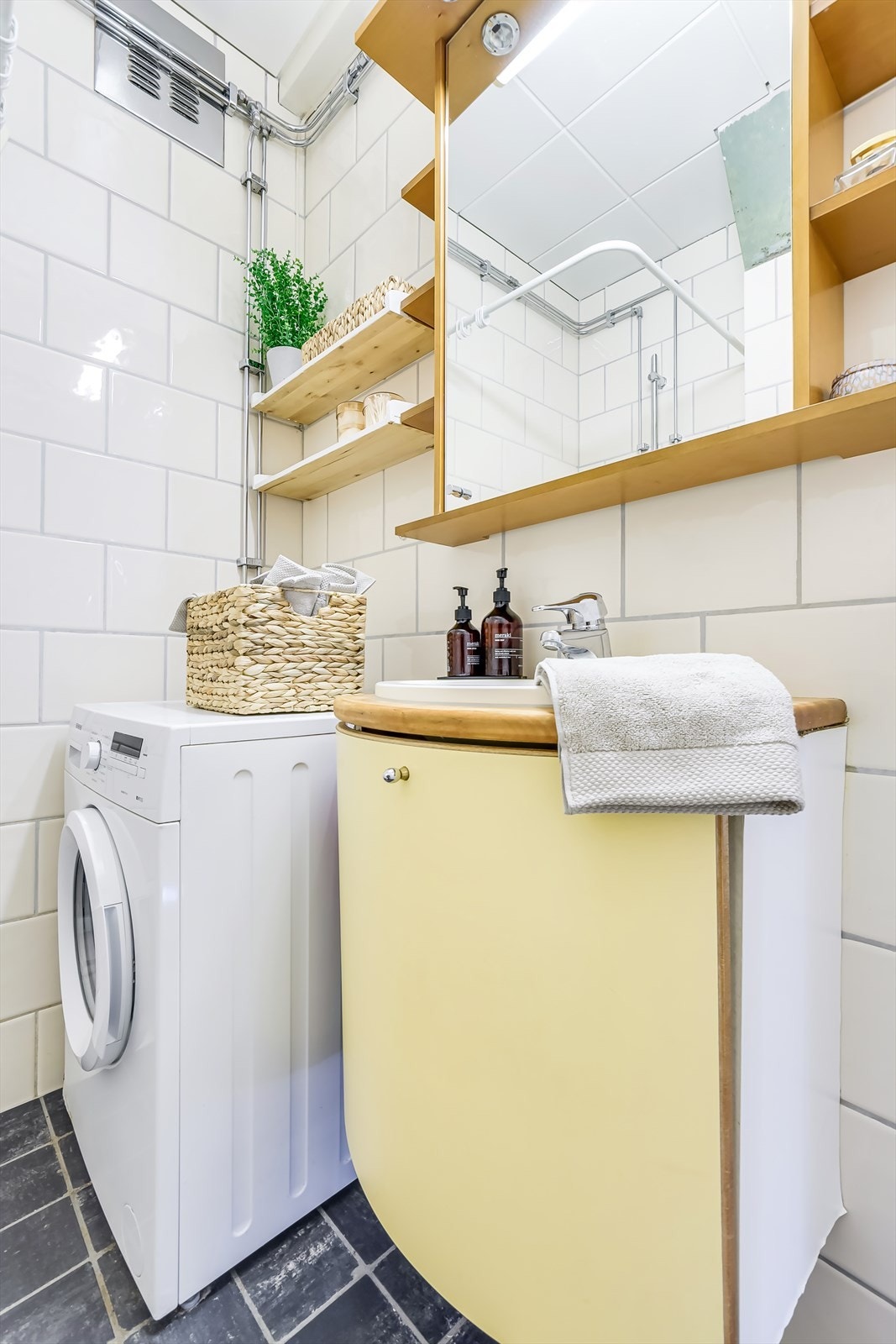 Baderomsinnredningen består av servant i skapseksjon og overskap for oppbevaring Galleribilde