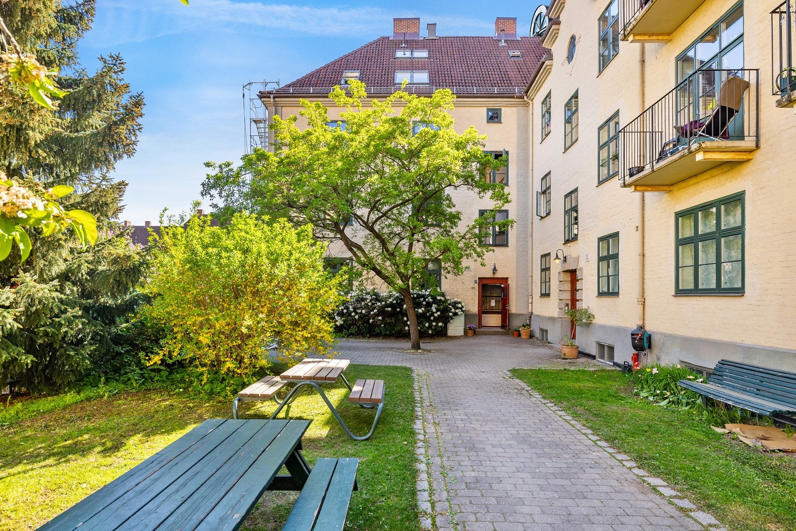 Vakker beplantet bakgård med hyggelige sittegrupper. Galleribilde