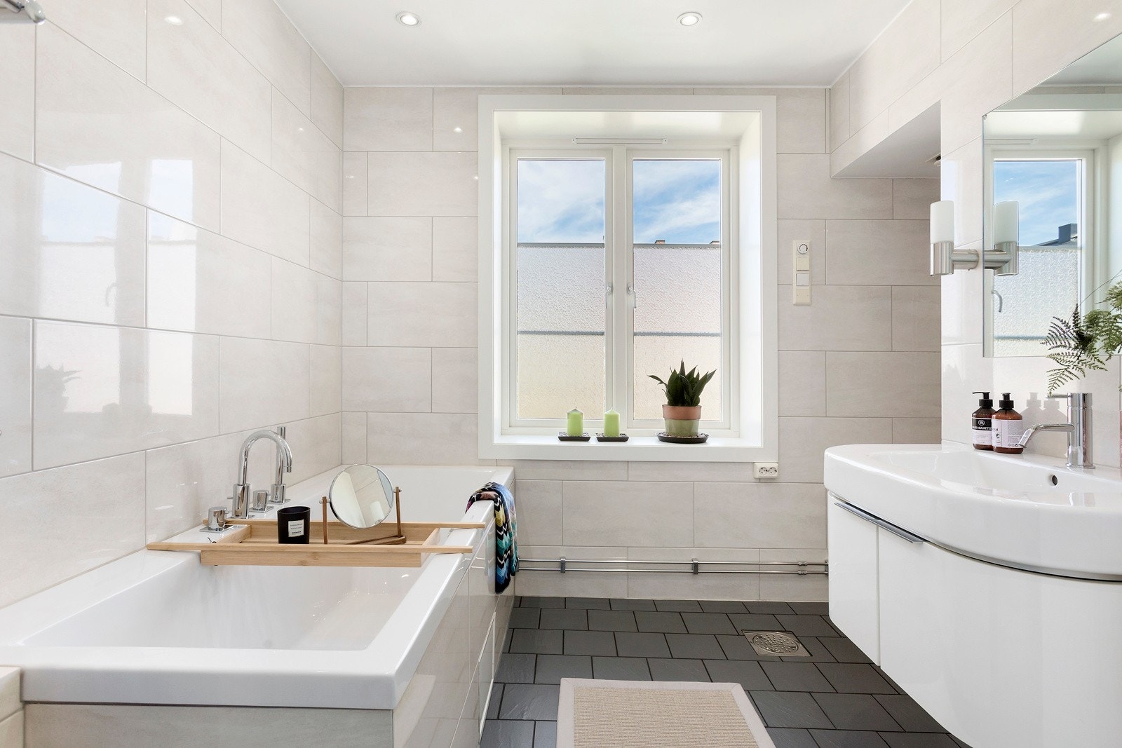 Badet er utstyrt med badekar og lys innredning. Galleribilde